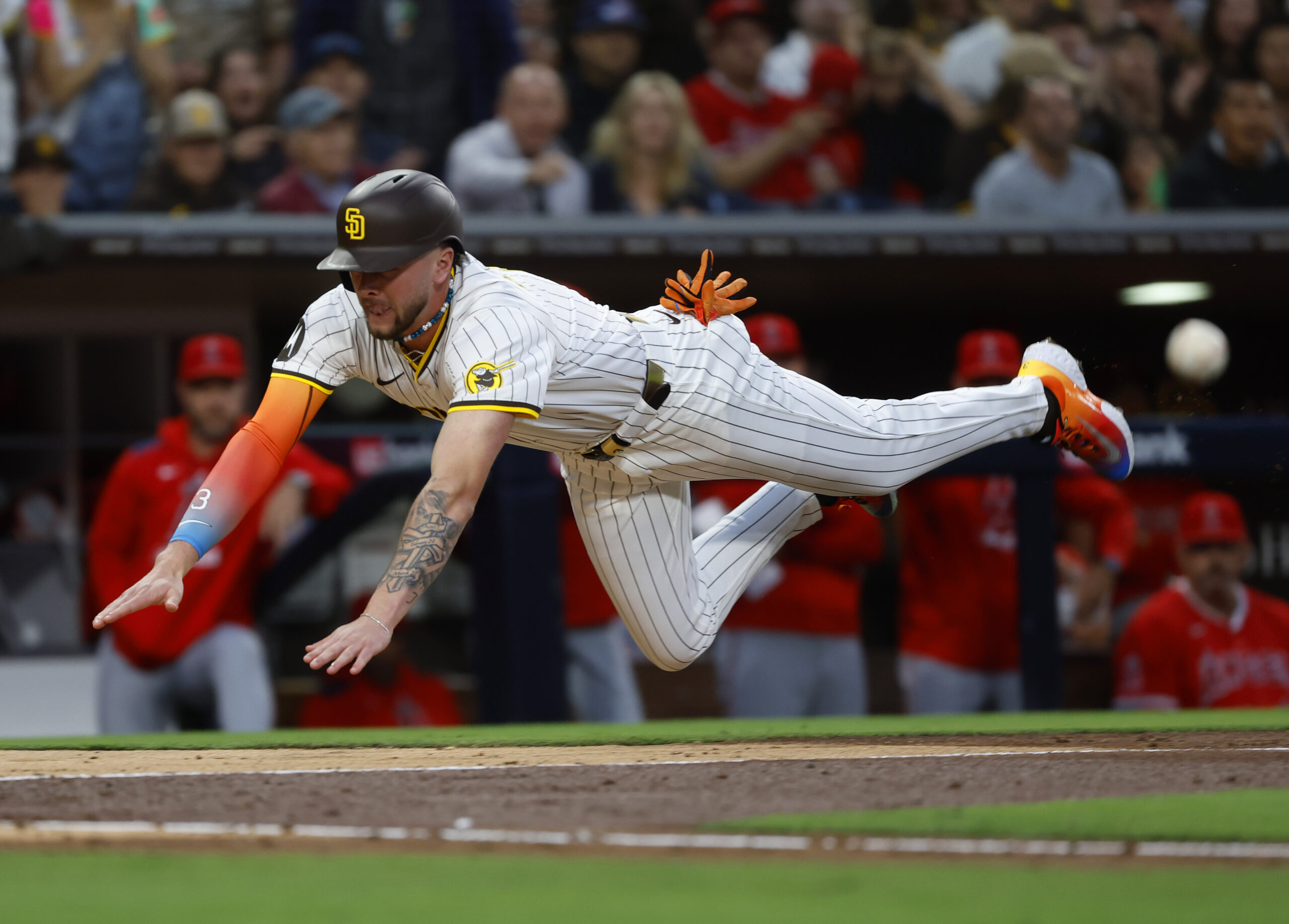 San Diego Padres’ Jackson Merrill scores on a throwing error in...