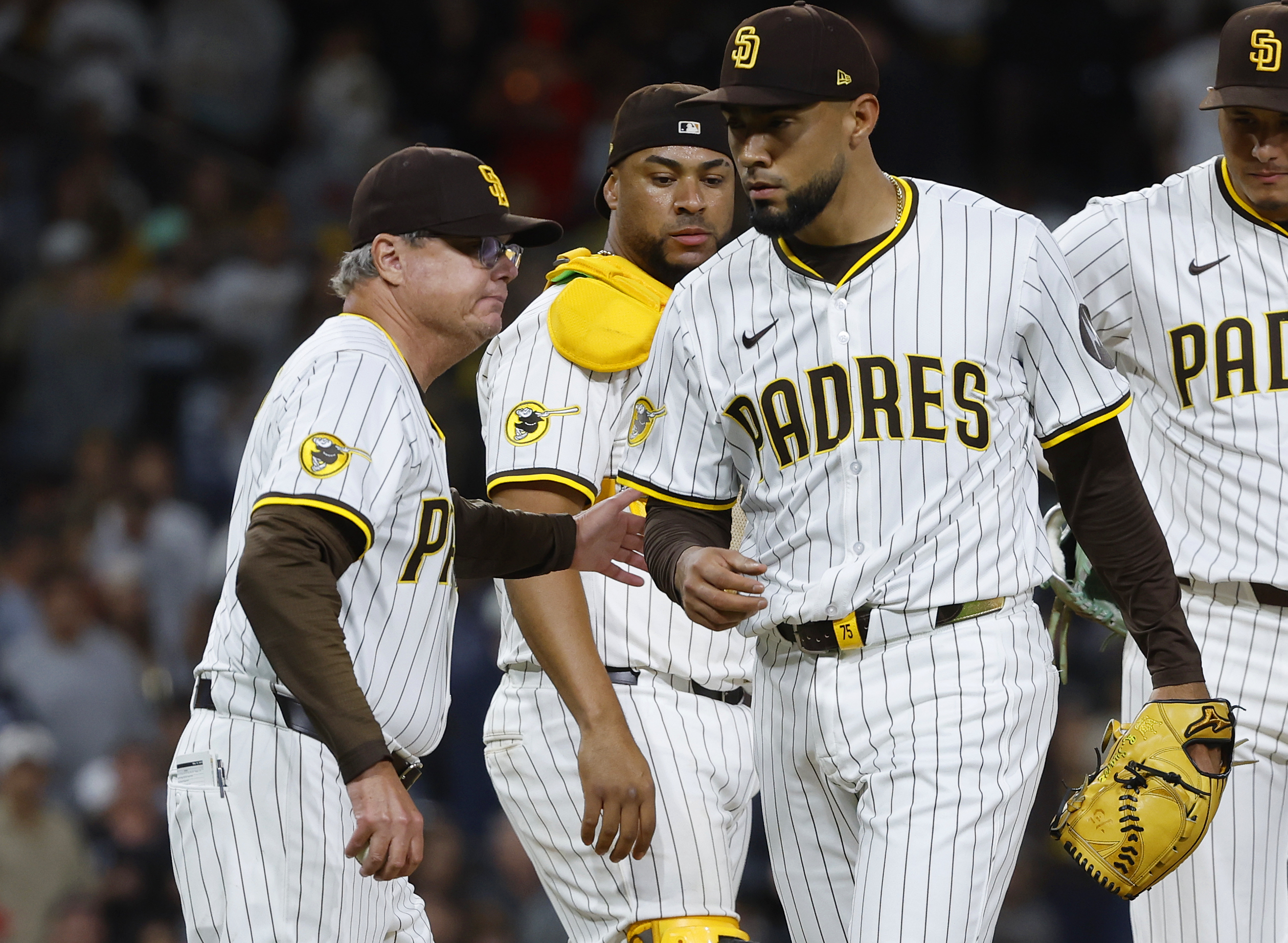 San Diego Padres’ Robert Suarez is pulled from the game by...
