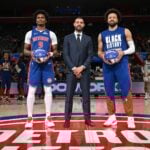 Feb 9, 2025; Detroit, Michigan, USA; Detroit Pistons forward Ausar Thompson (9) and Detroit Pistons guard Cade Cunningham (2) stand at center court with Detroit Pistons President of Basketball Operations Trajan Langdon to be recognized for being named to the NBA All-Star Team before their game against the Charlotte Hornets at Little Caesars Arena. Mandatory Credit: Lon Horwedel-Imagn Images