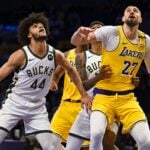 Mar 20, 2025; Los Angeles, California, USA; Los Angeles Lakers center Alex Len (27) attempts to gain possession against Milwaukee Bucks guard Andre Jackson Jr. (44) during the second half at Crypto.com Arena. Mandatory Credit: Jonathan Hui-Imagn Images