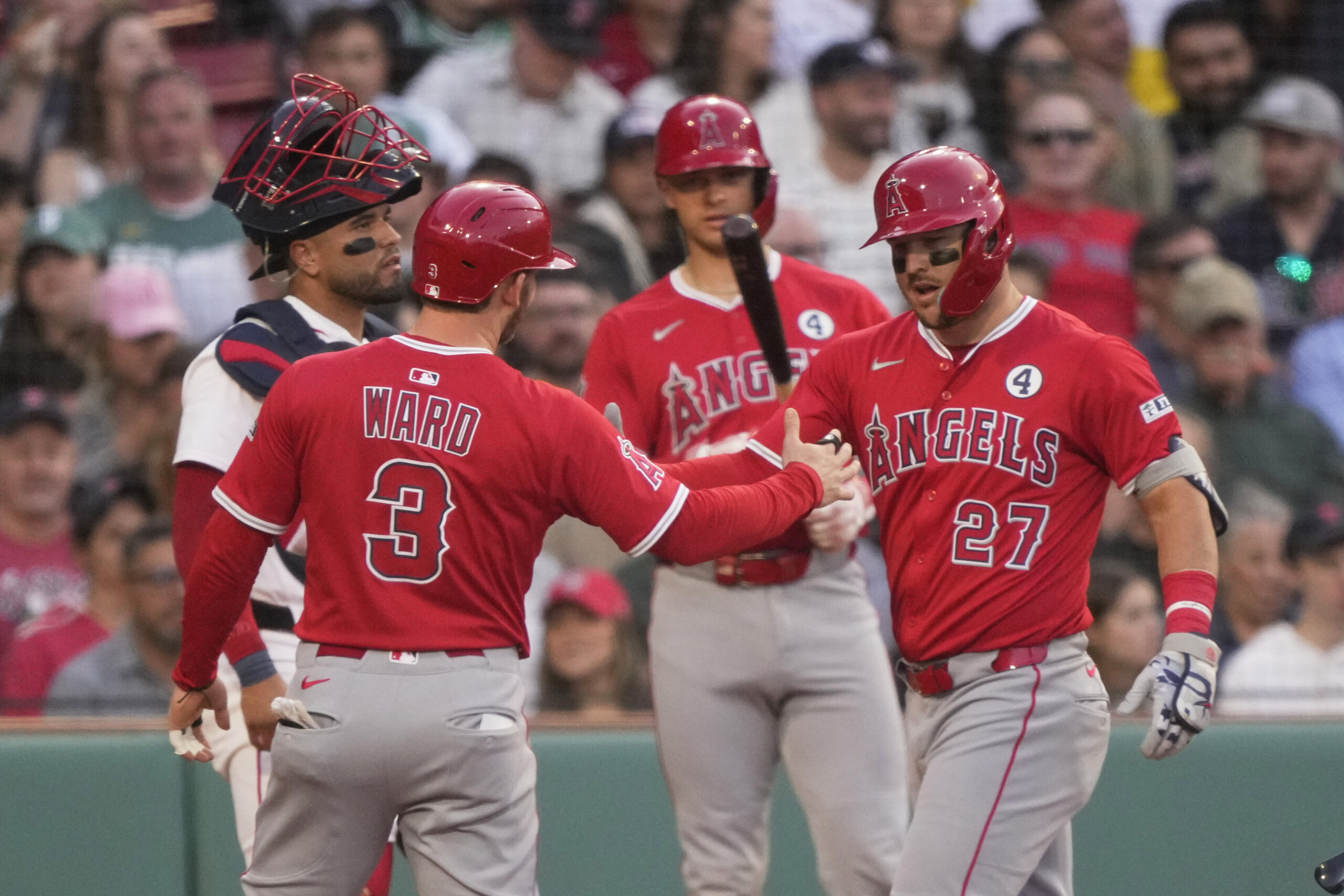 Angels star Mike Trout, right, is congratulated by Taylor Ward,...