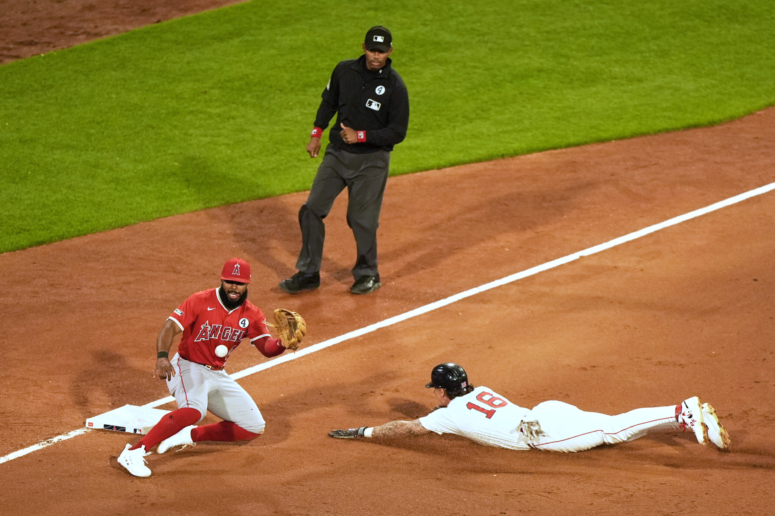 The Boston Red Sox’s Jarren Duran slides into third base...