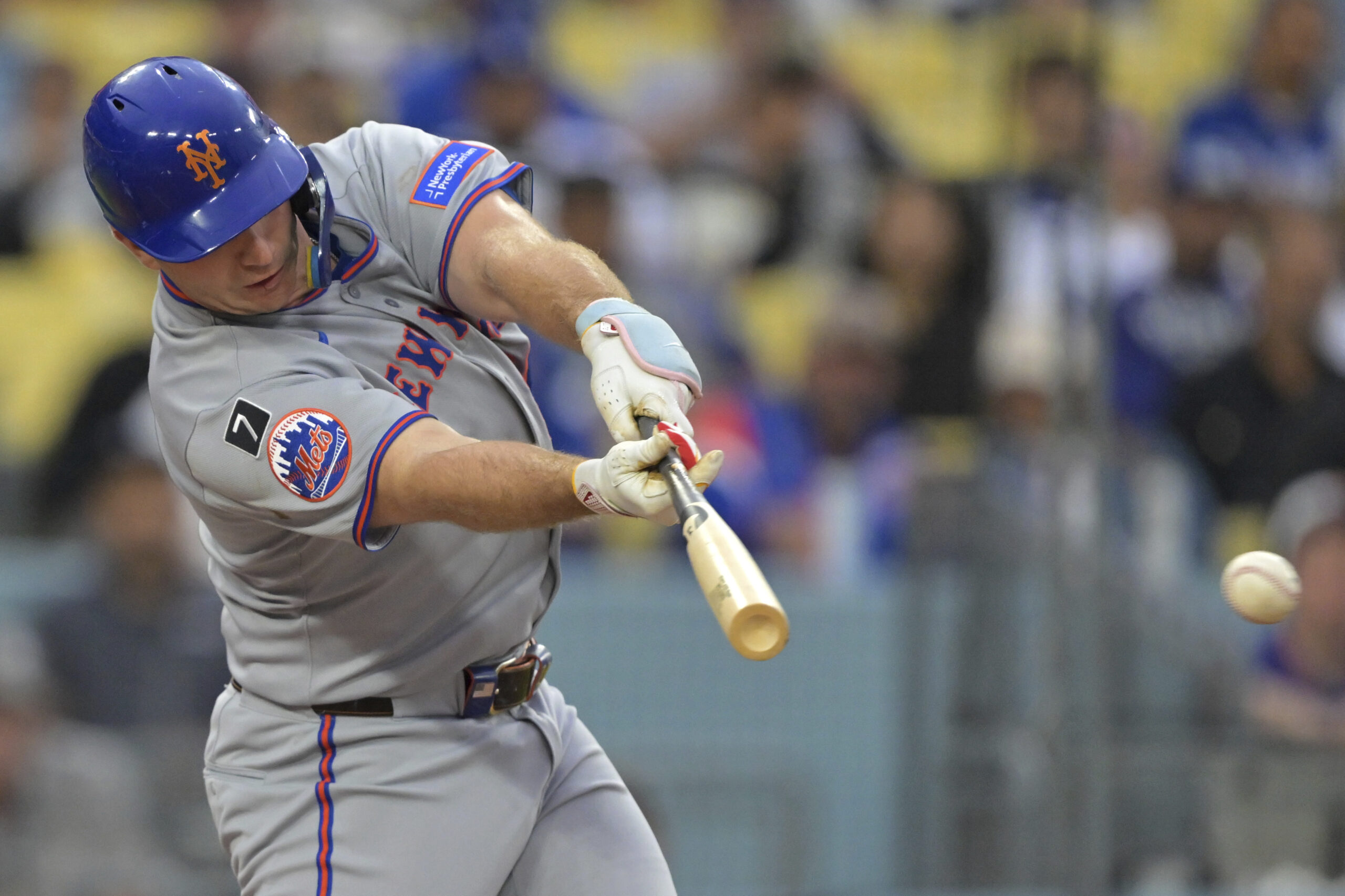 The New York Mets’ Pete Alonso singles in a run...