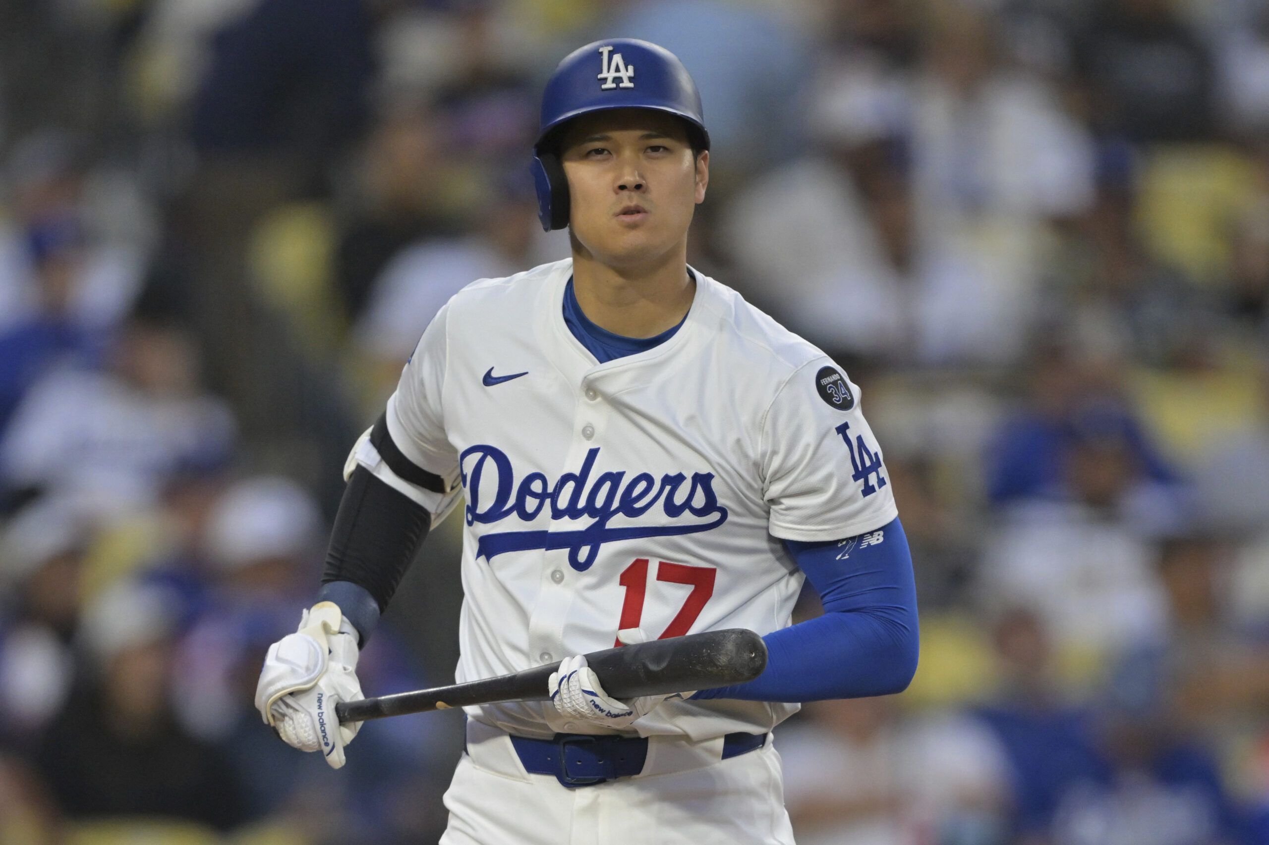 Dodgers star Shohei Ohtani reacts after a strike during the...