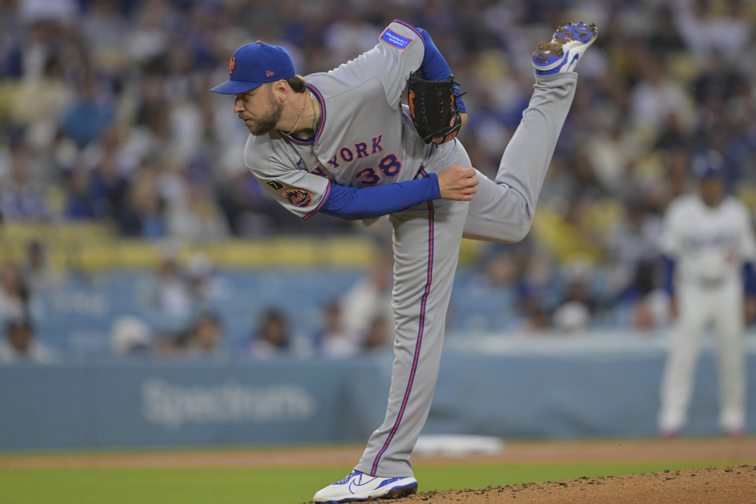 New York Mets starting pitcher Tylor Megill throws to the...