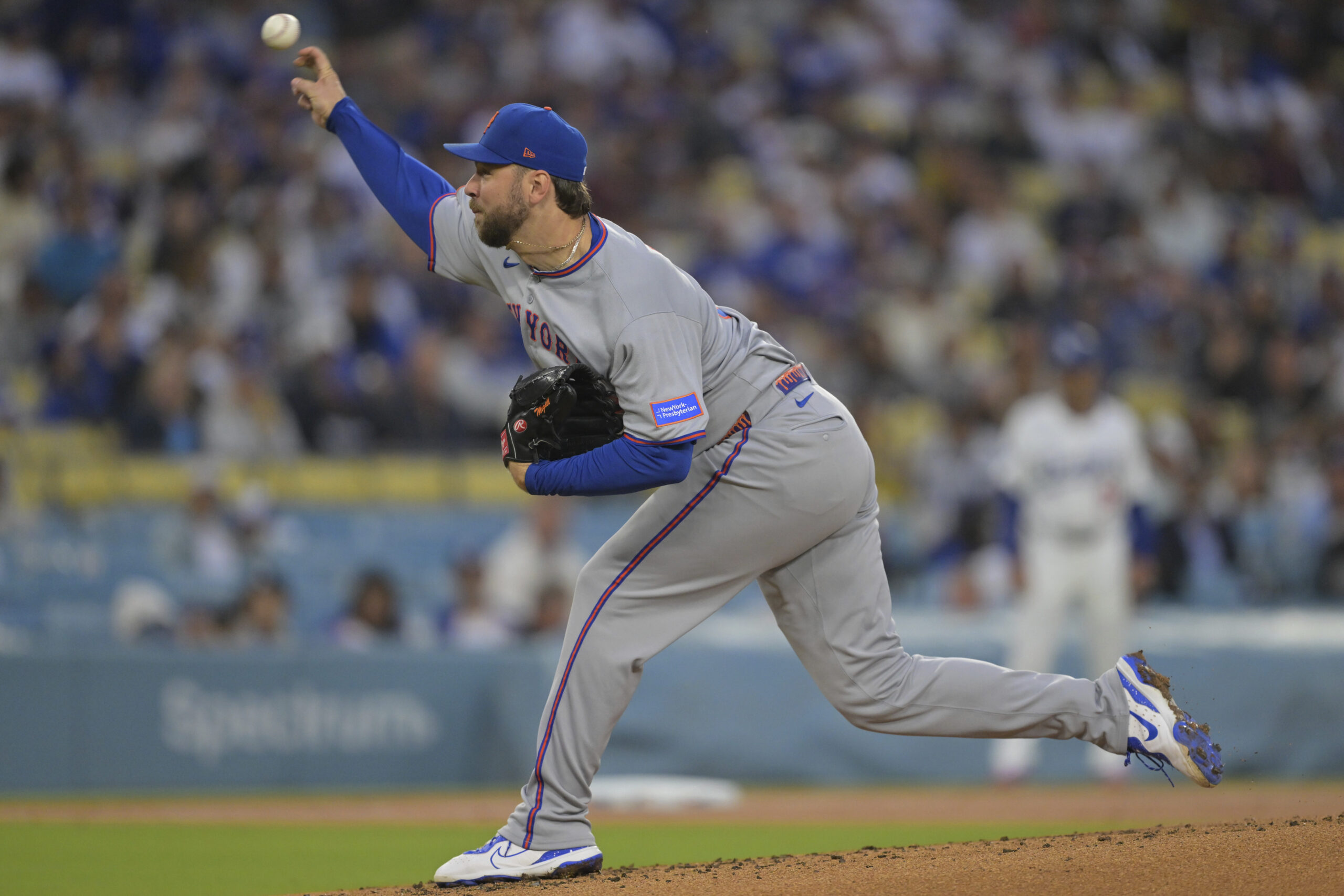 New York Mets starting pitcher Tylor Megill throws to the...
