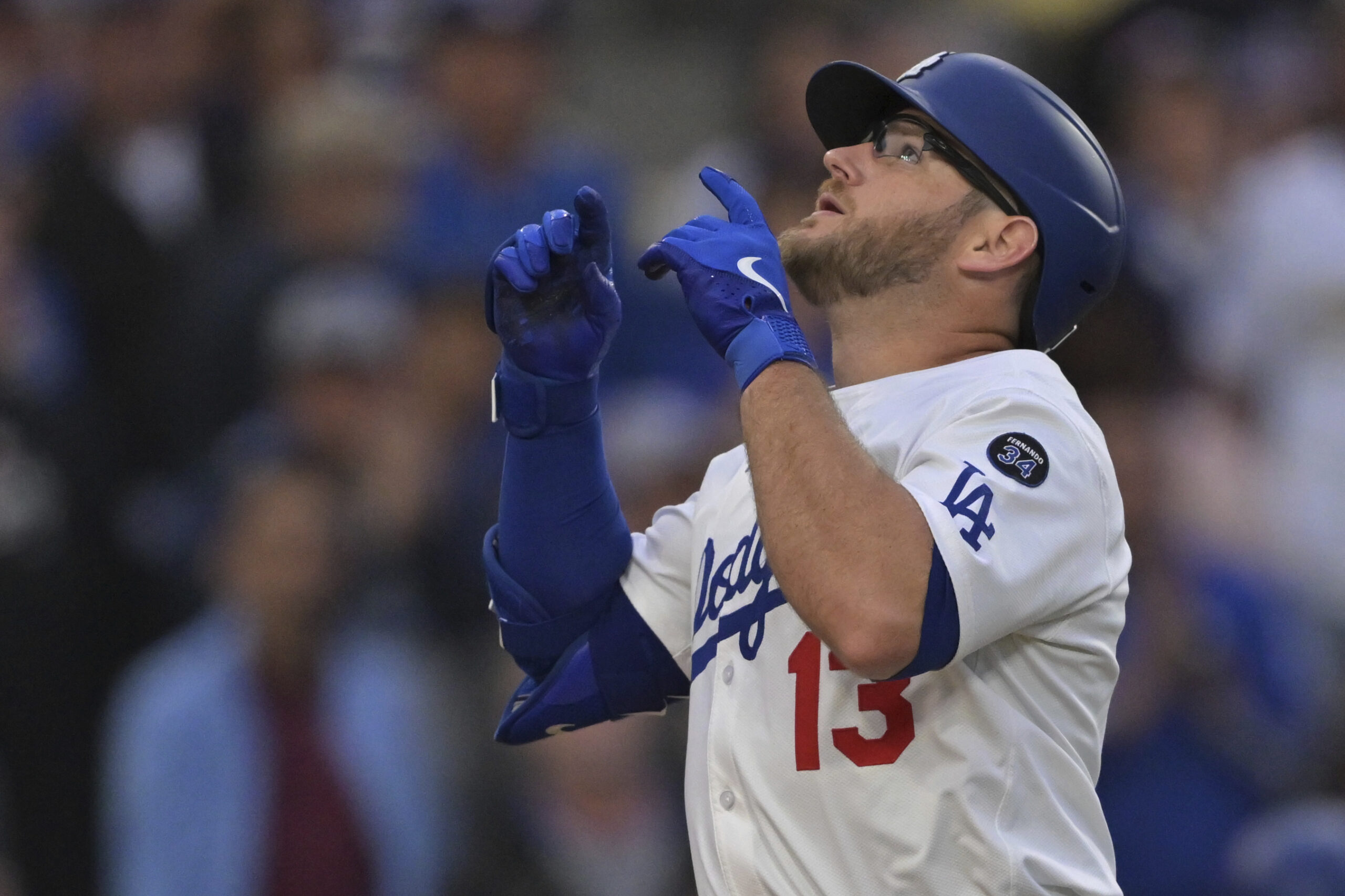 The Dodgers’ Max Muncy gestures as he crosses the plate...