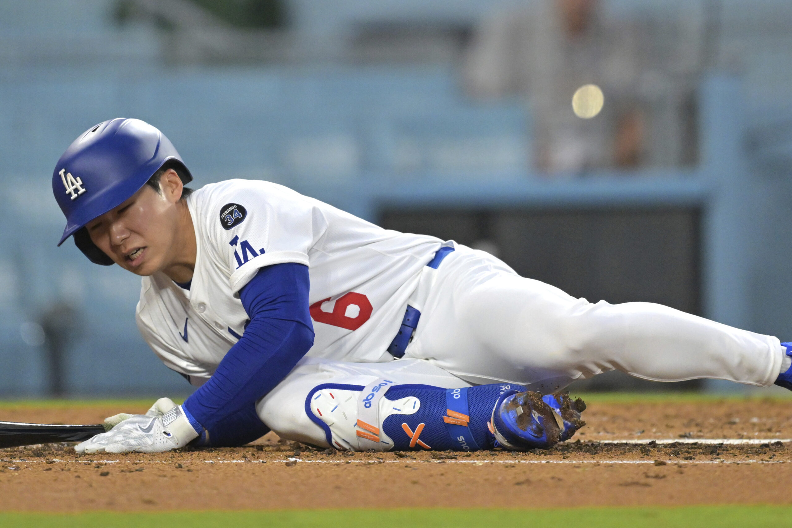 The Dodgers’ Hyeseong Kim falls to the ground while at...