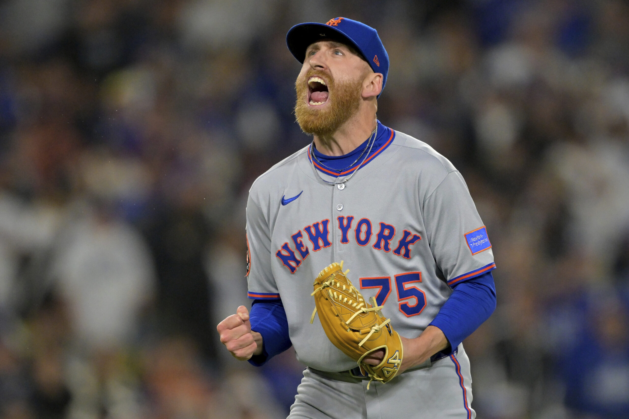 New York Mets relief pitcher Reed Garrett reacts after striking...
