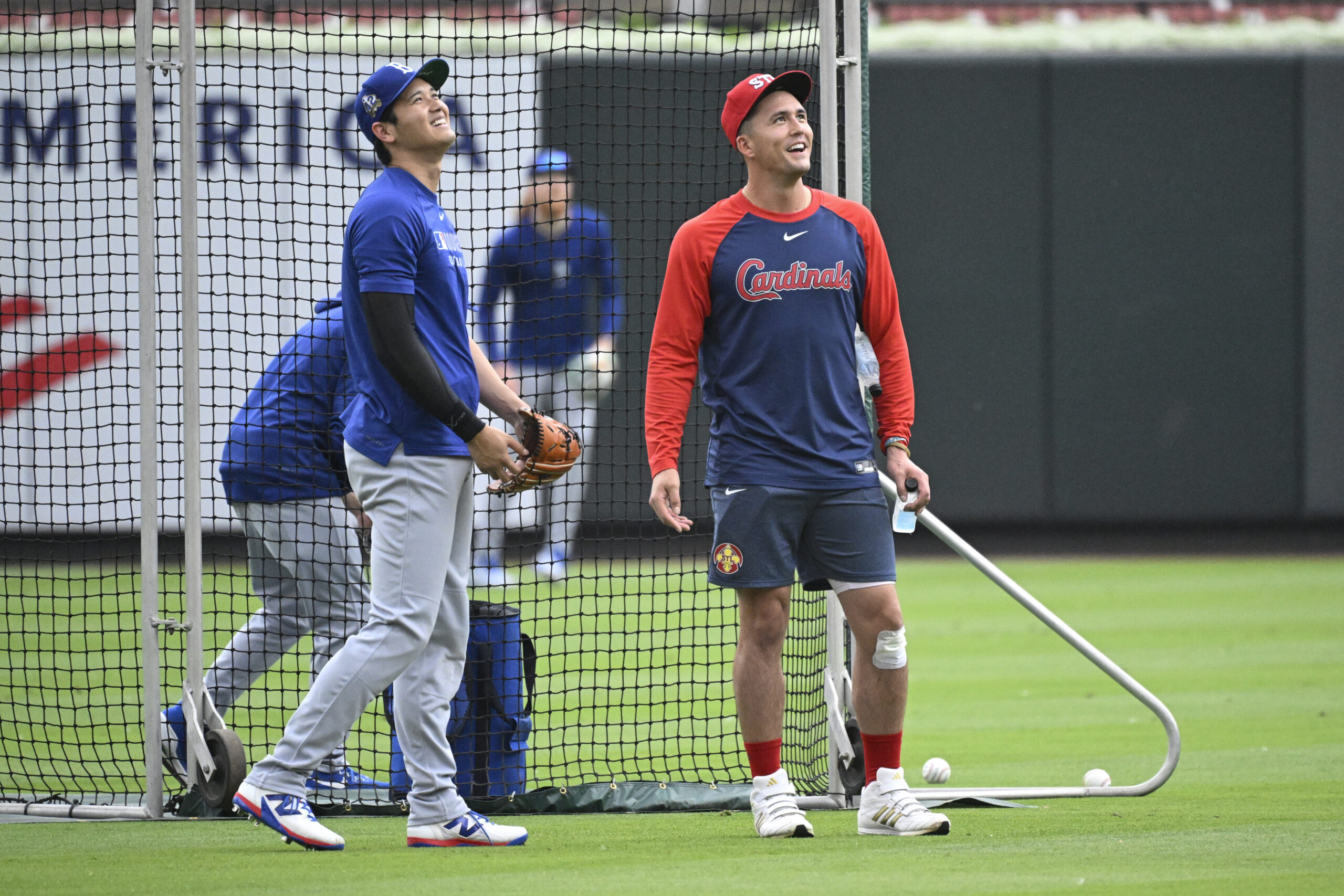 Dodgers star Shohei Ohtani, left, speaks with the St. Louis...