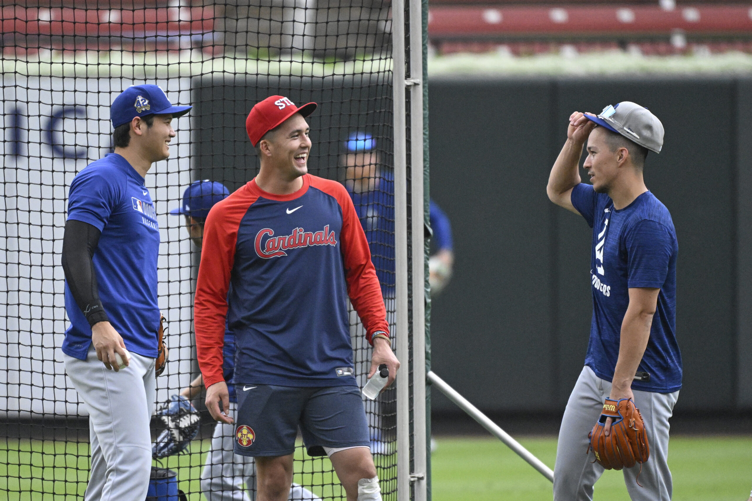 The Dodgers’ Shohei Ohtani, left, and teammate Tommy Edman, right,...