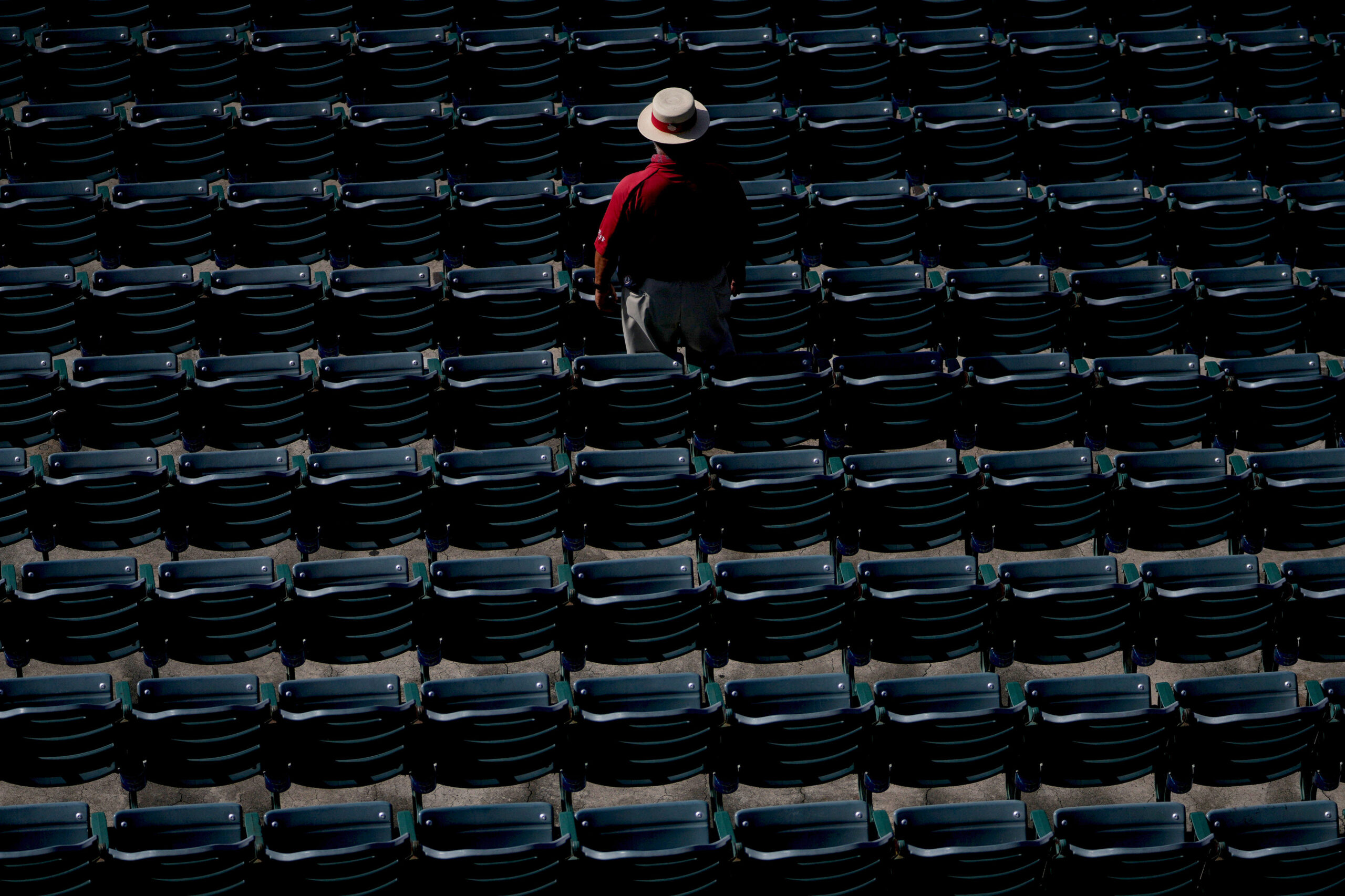 An usher stands in a row of seats before a...
