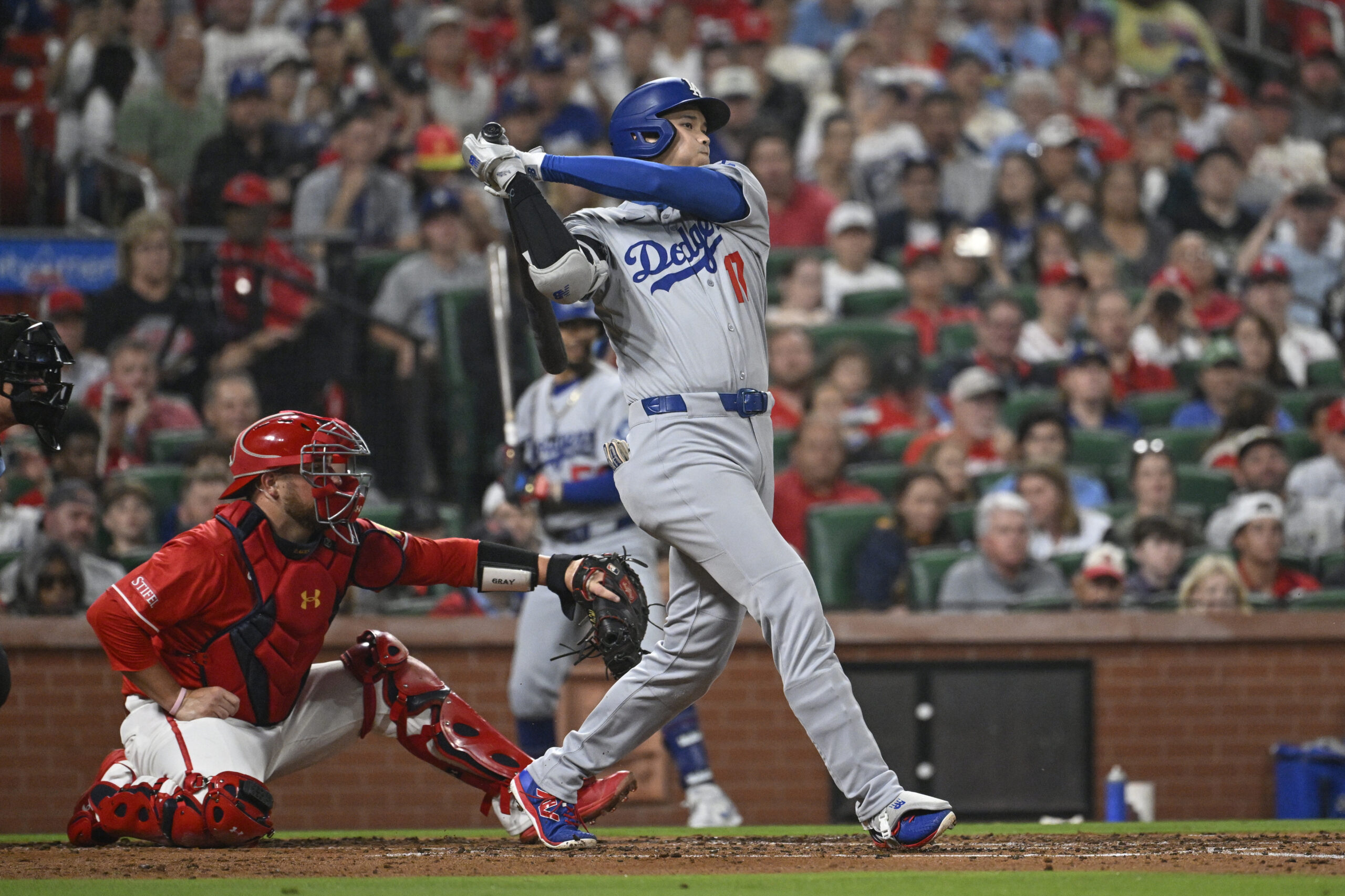 Dodgers star Shohei Ohtani hits a single during the third...