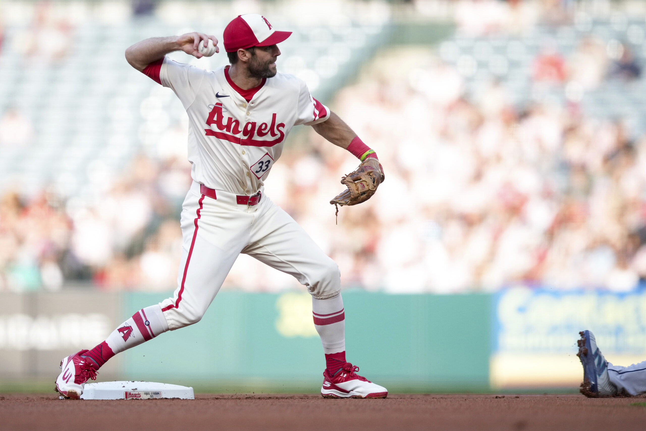 Angels second baseman Chris Taylor throws to first as Seattle...