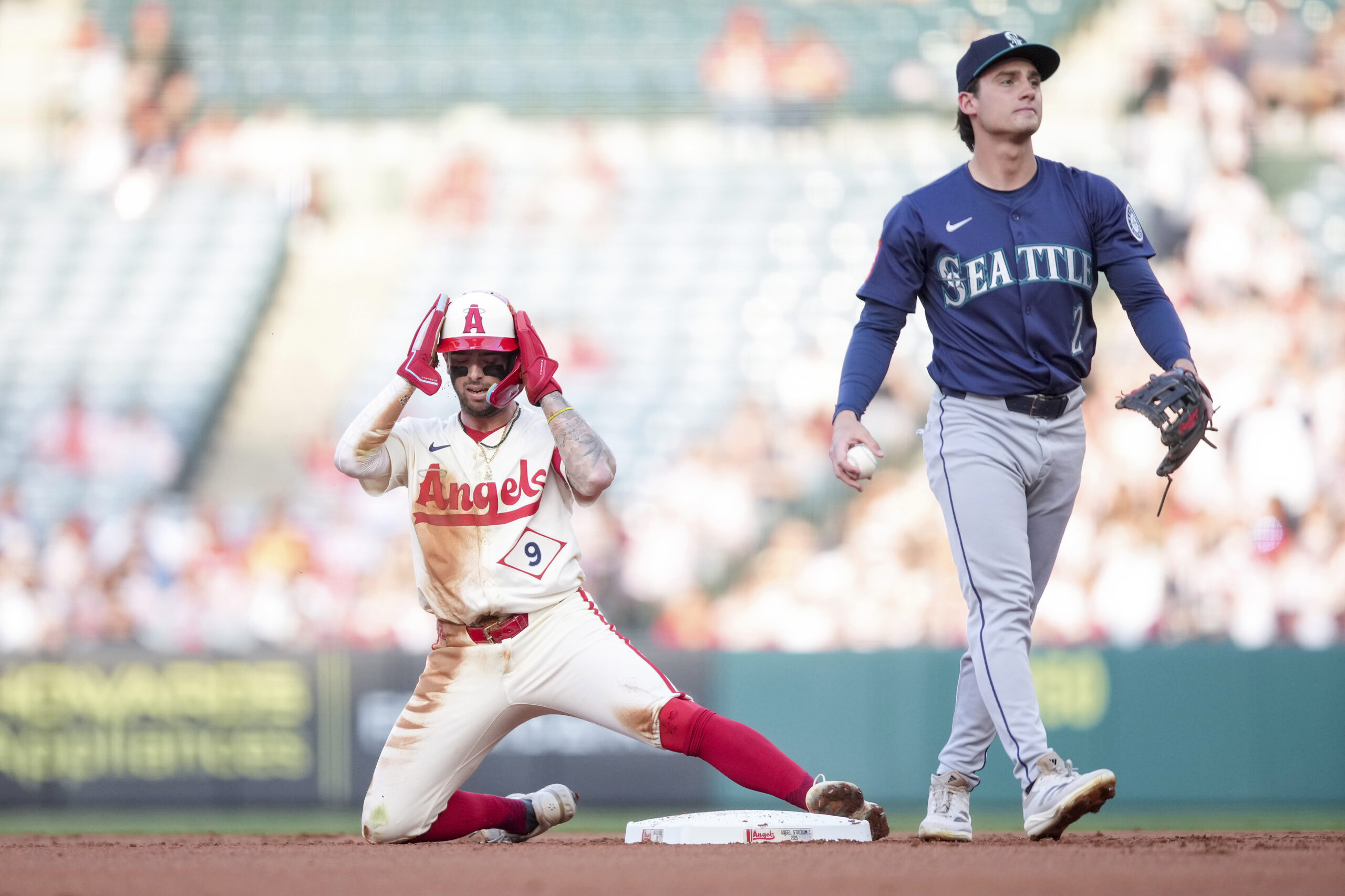 The Angels’ Zach Neto reacts after stealing second base as...
