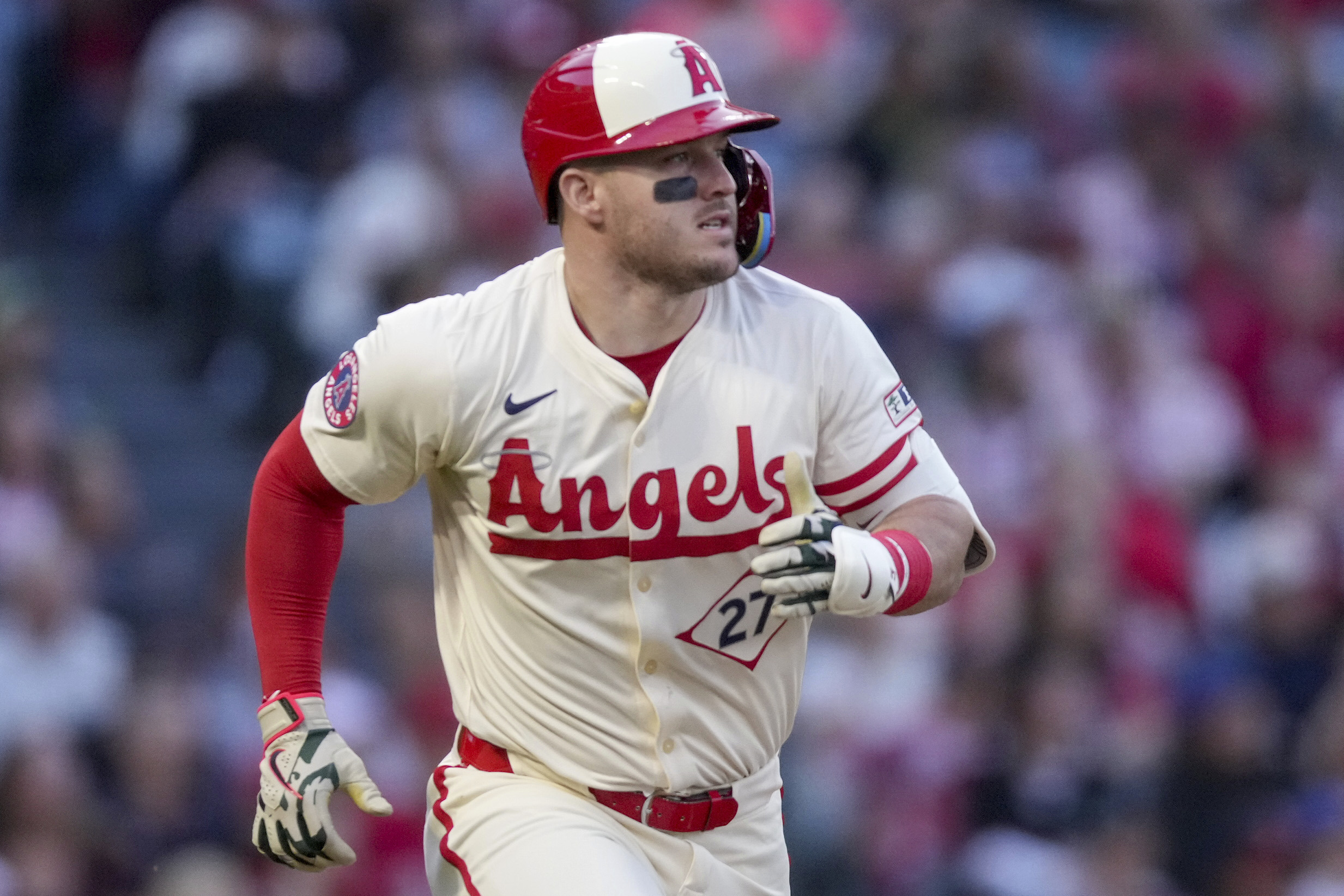 Angels designated hitter Mike Trout runs to first base during...