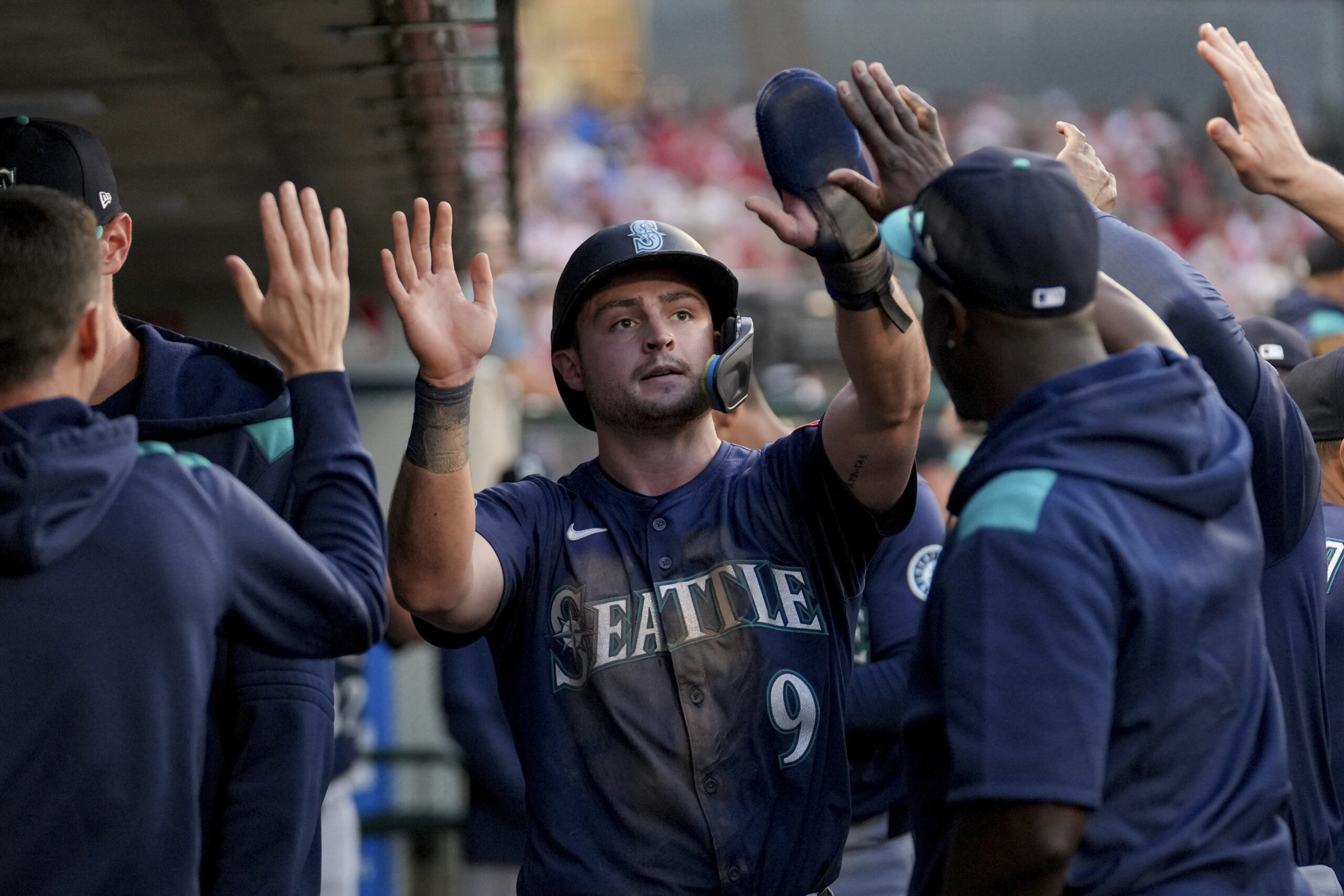 The Seattle Mariners’ Ben Williamson (9) celebrates with teammates in...