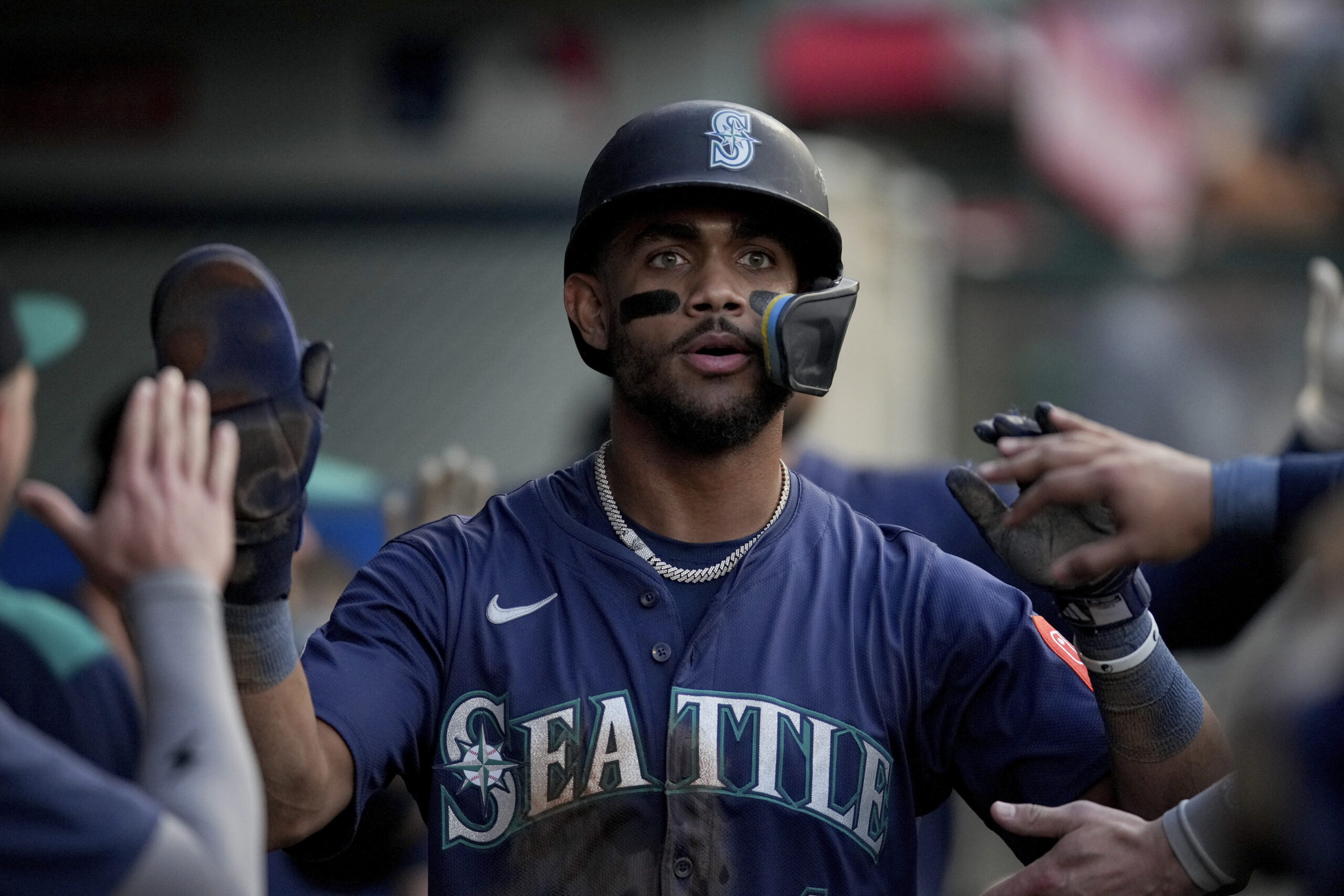 The Seattle Mariners’ Julio Rodriguez celebrates with teammates in the...