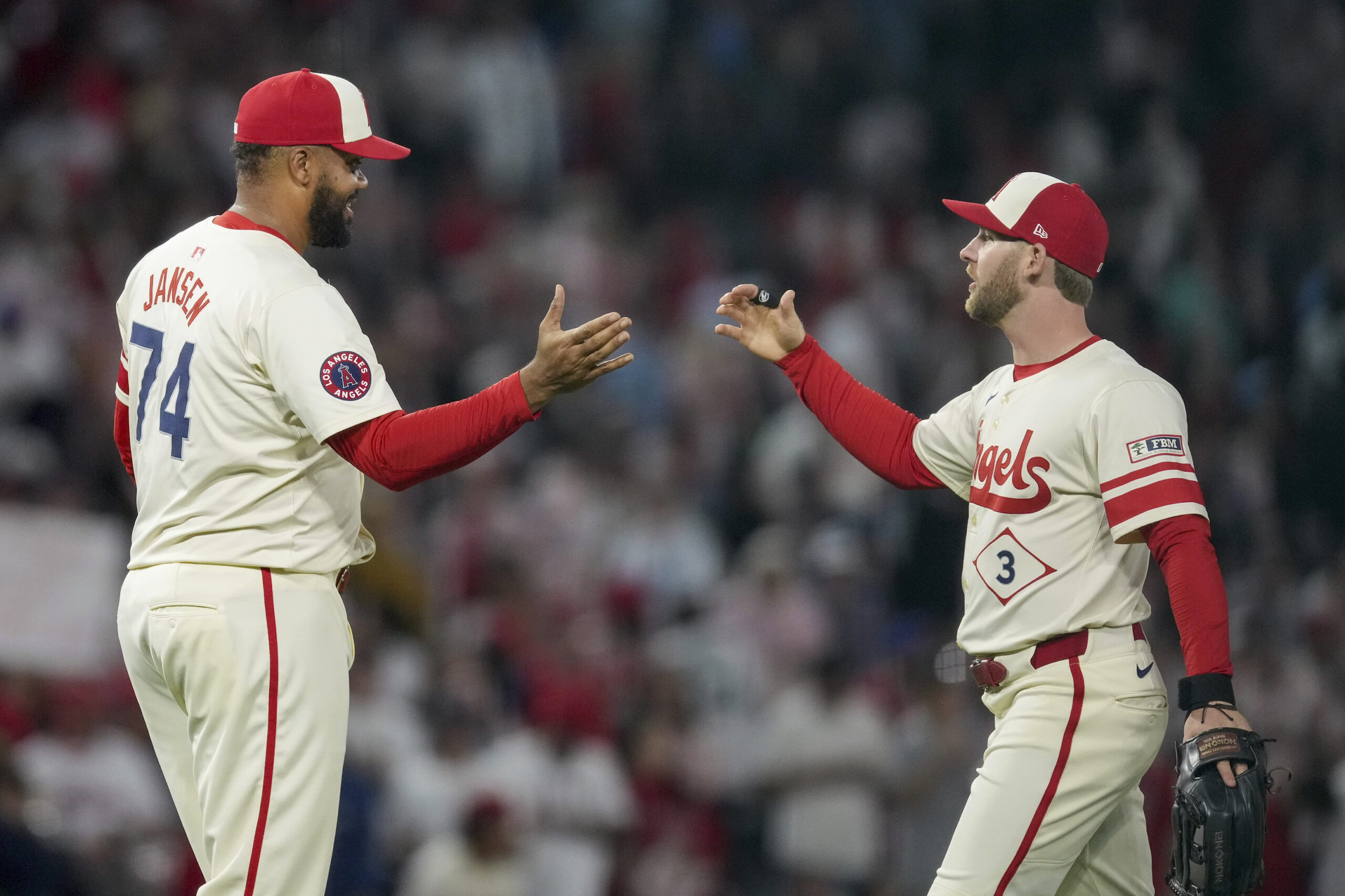 Angels relief pitcher Kenley Jansen, left, and outfielder Taylor Ward...