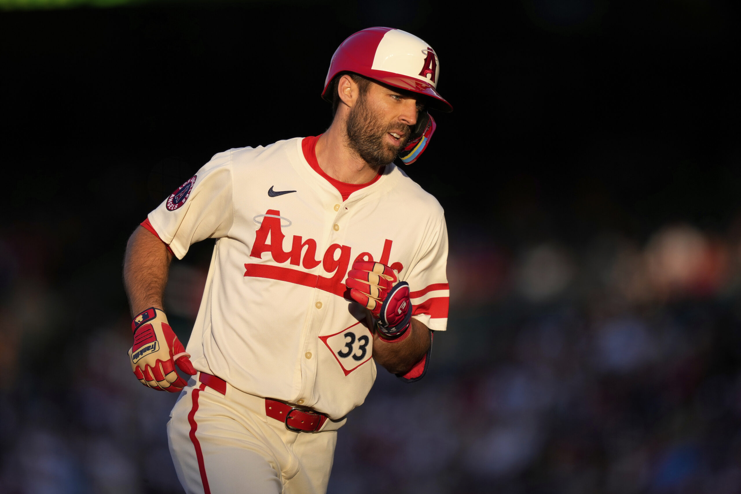 Angels’ Chris Taylor rounds third after hitting a solo home...