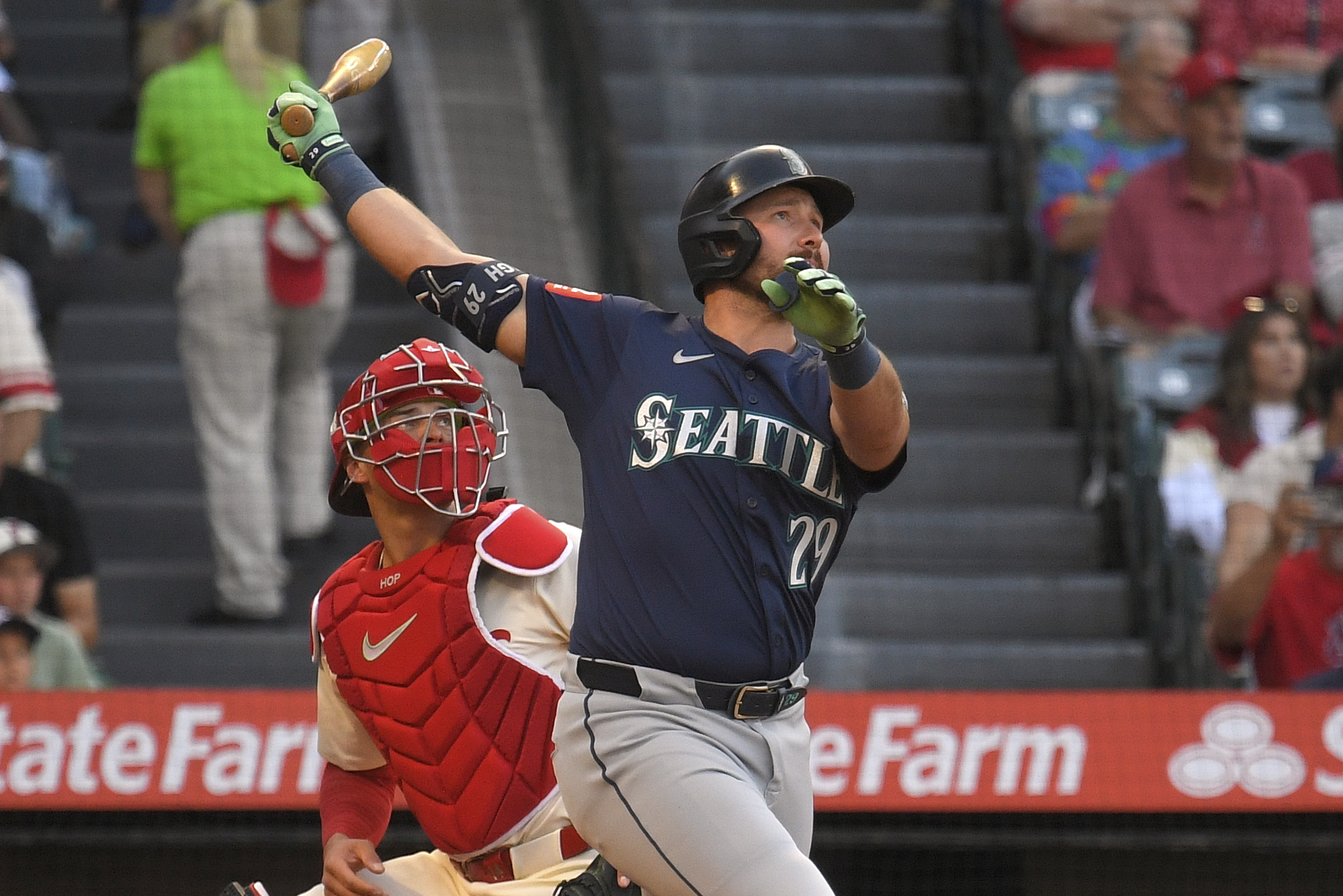 Seattle Mariners’ Cal Raleigh, right, hits a two-run home run...