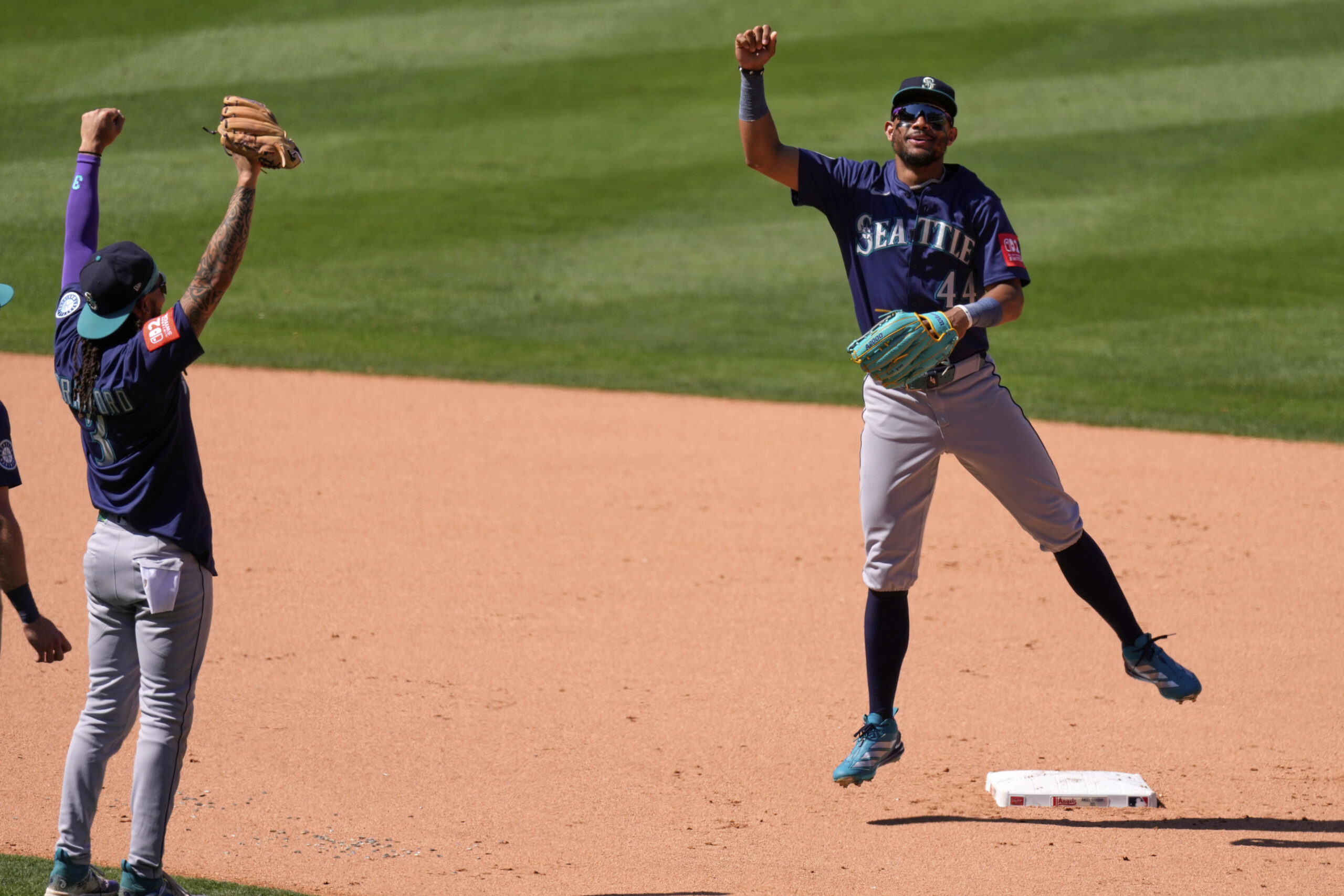 Seattle Mariners’ Julio Rodriguez, right, celebrates with J.P. Crawford after...