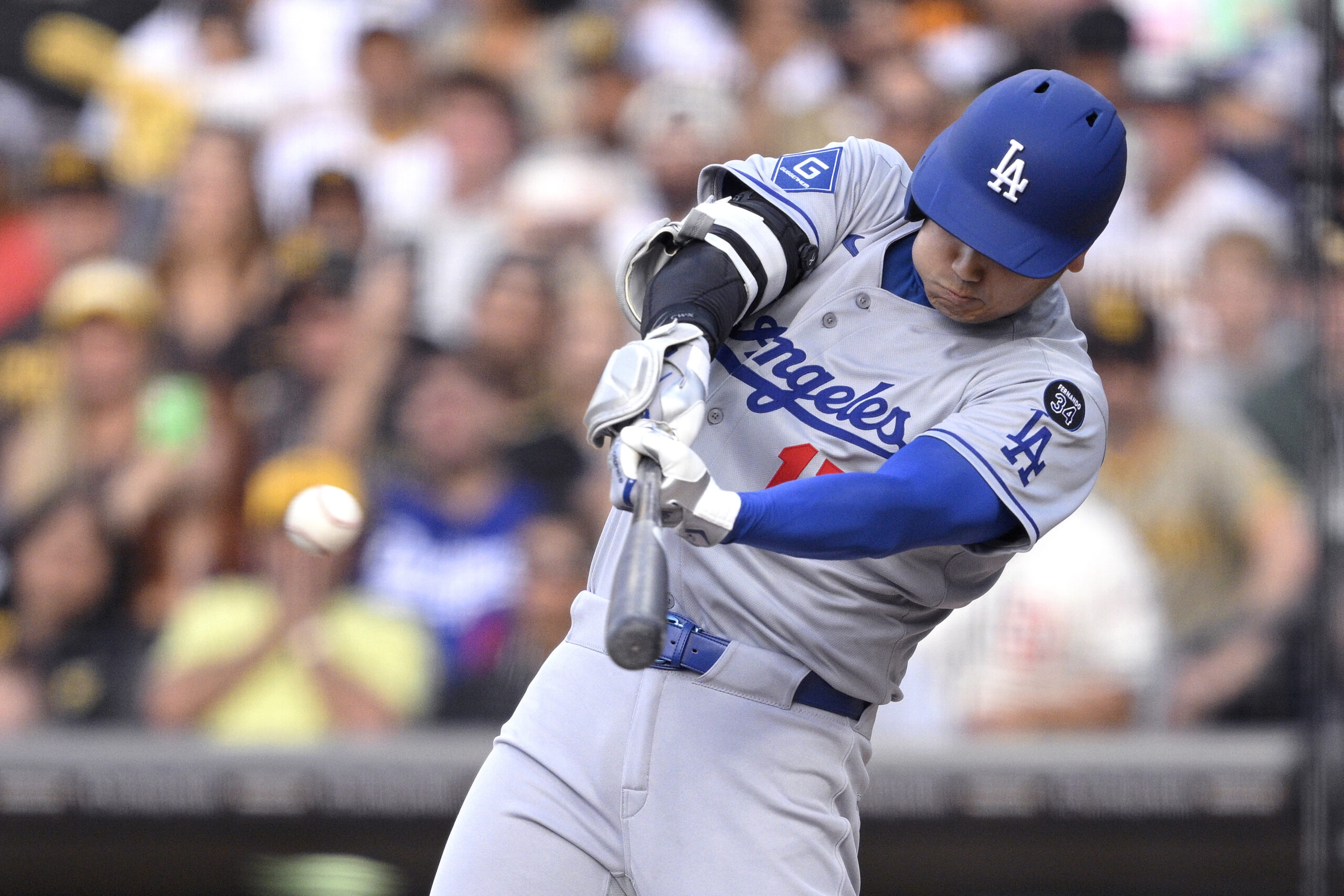 Dodgers star Shohei Ohtani hits a double against the San...