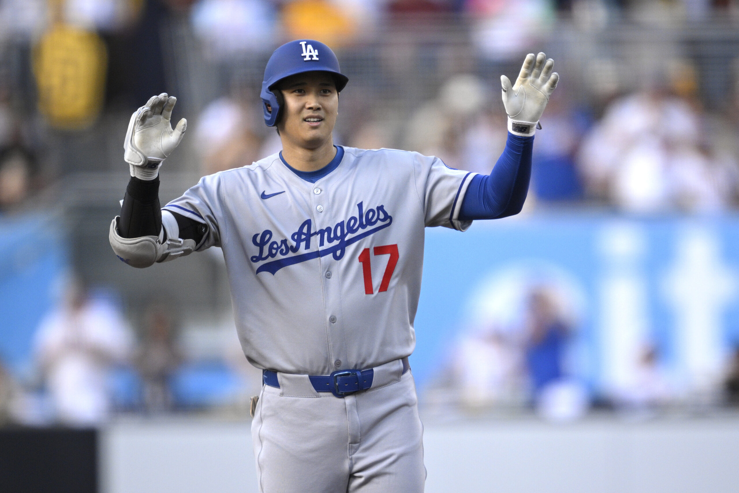 Dodgers star Shohei Ohtani celebrates at second base after hitting...