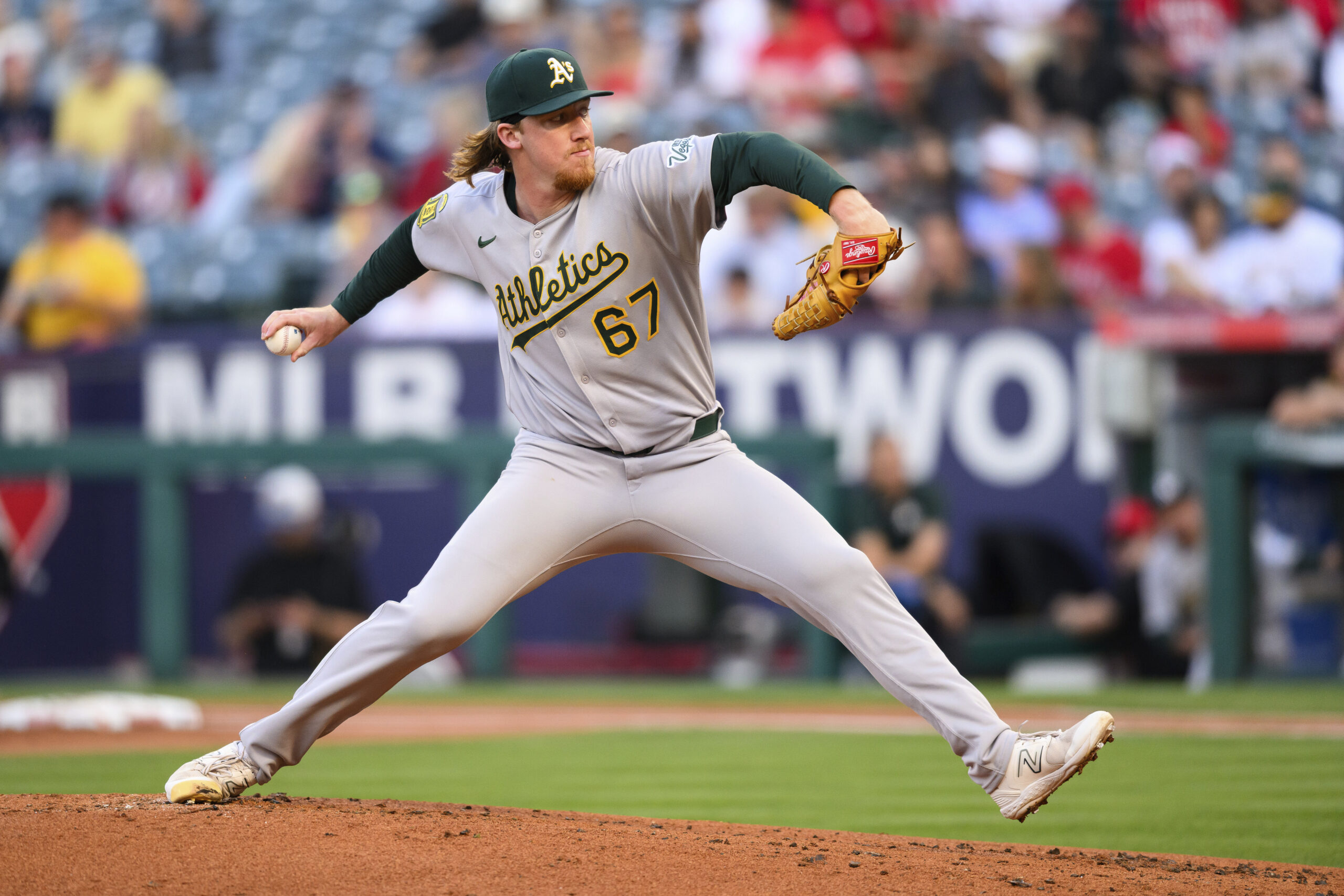 Athletics starting pitcher Grant Holman delivers a pitch during the...