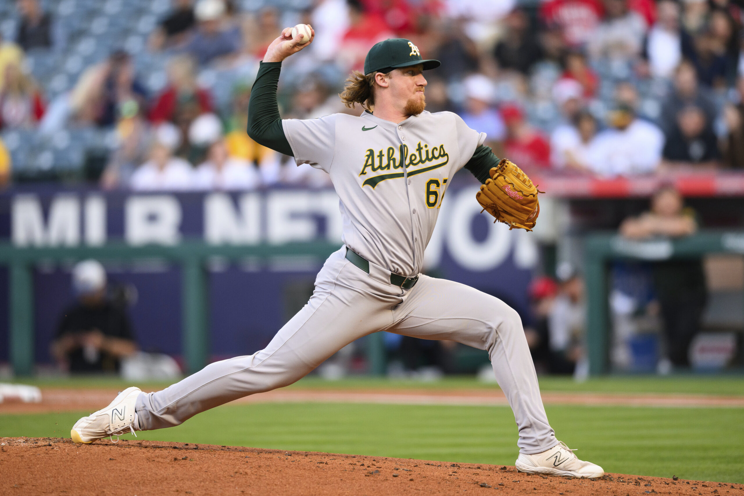 Athletics starting pitcher Grant Holman delivers a pitch during the...