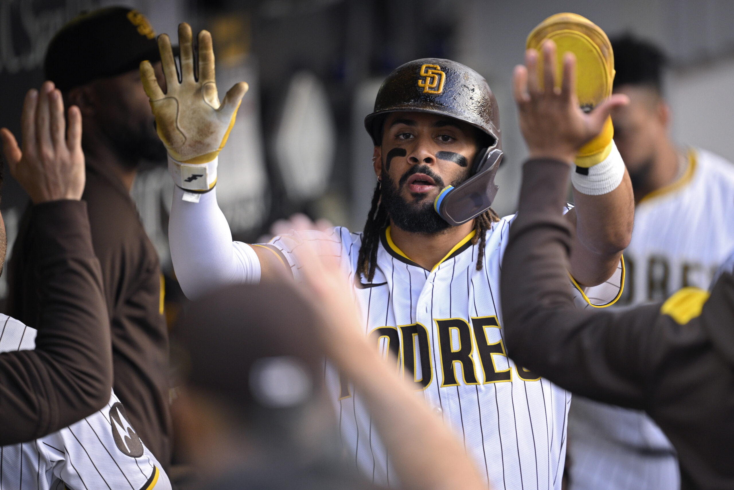 The San Diego Padres’ Fernando Tatis Jr. is congratulated in...