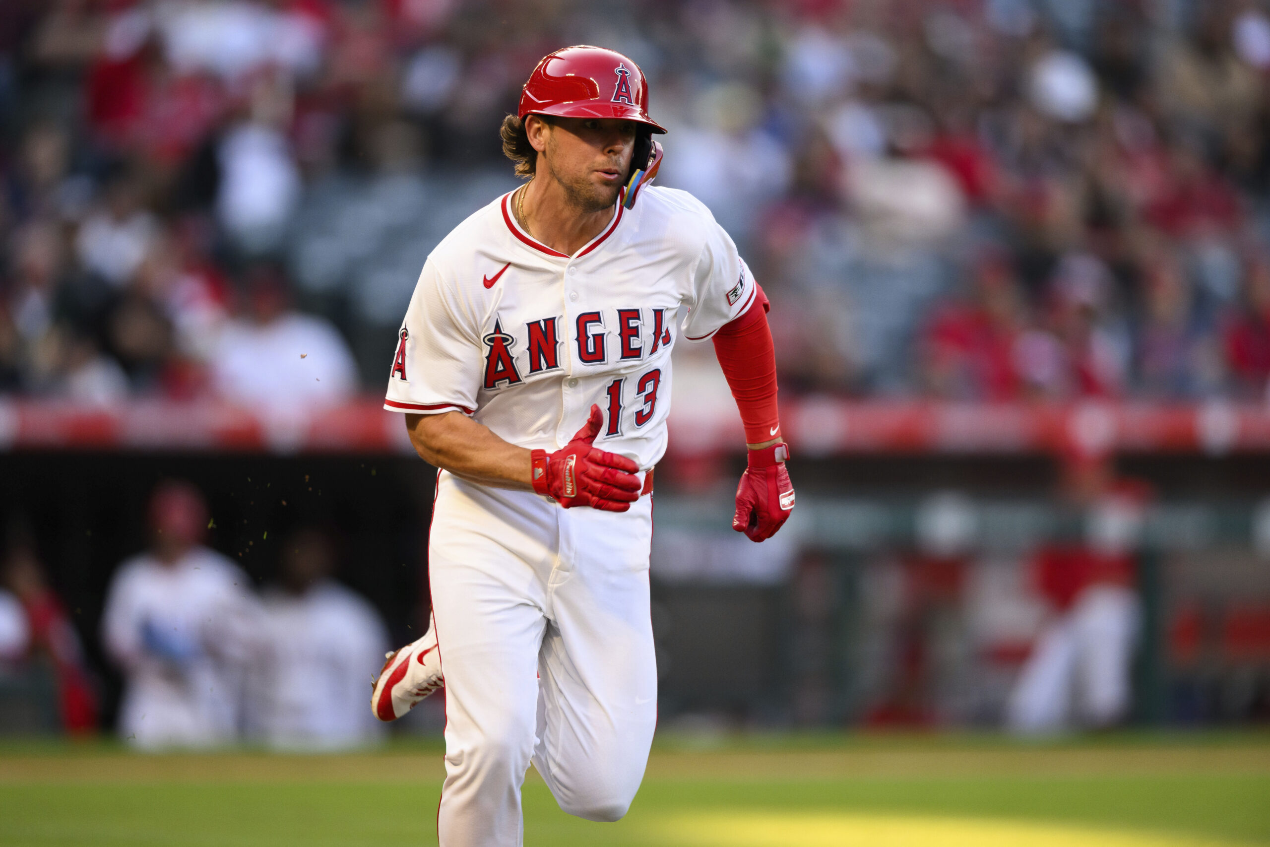 The Angels’ Scott Kingery runs to first base after bunting...
