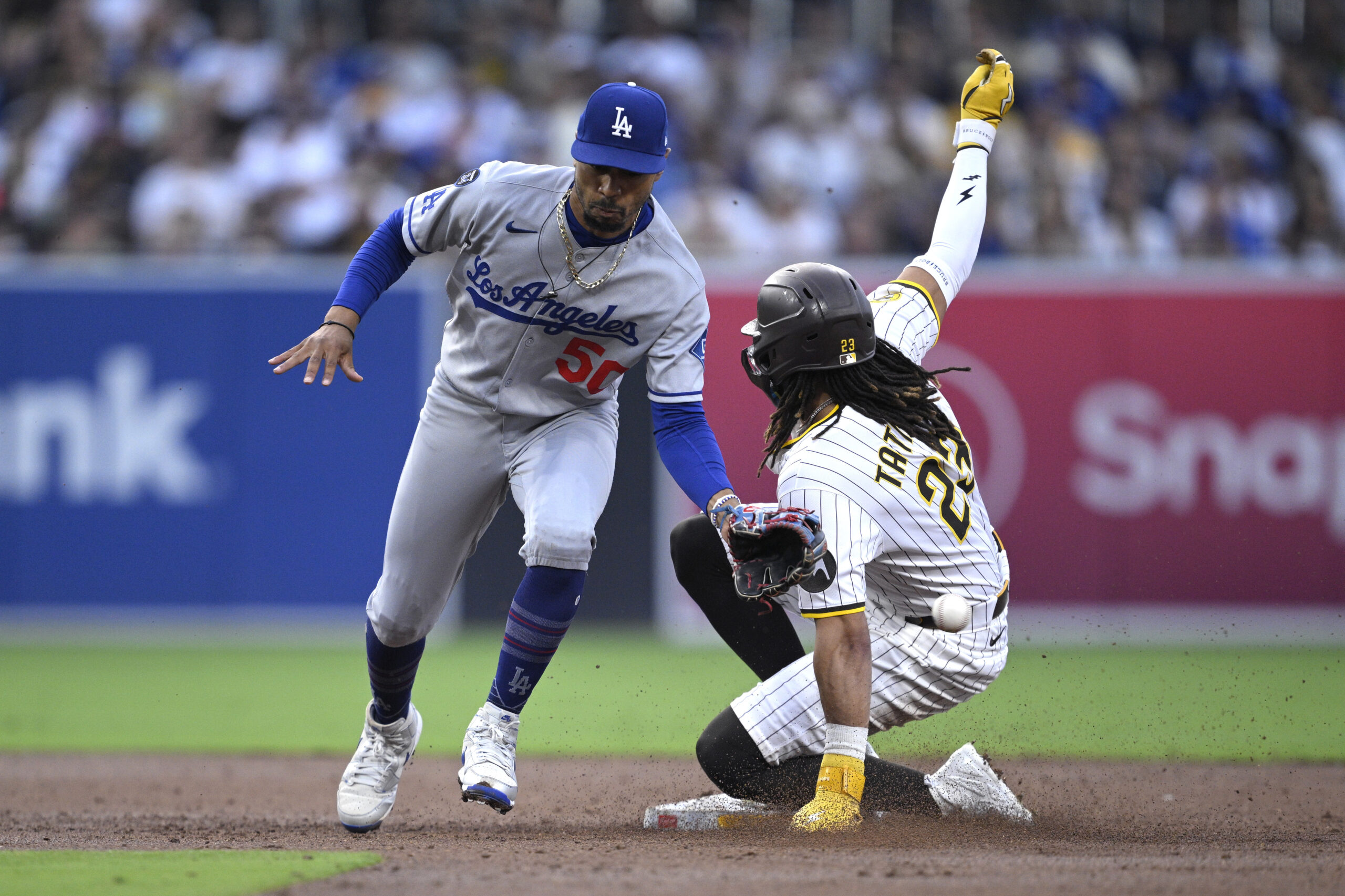 The San Diego Padres’ Fernando Tatis Jr., right, steals second...