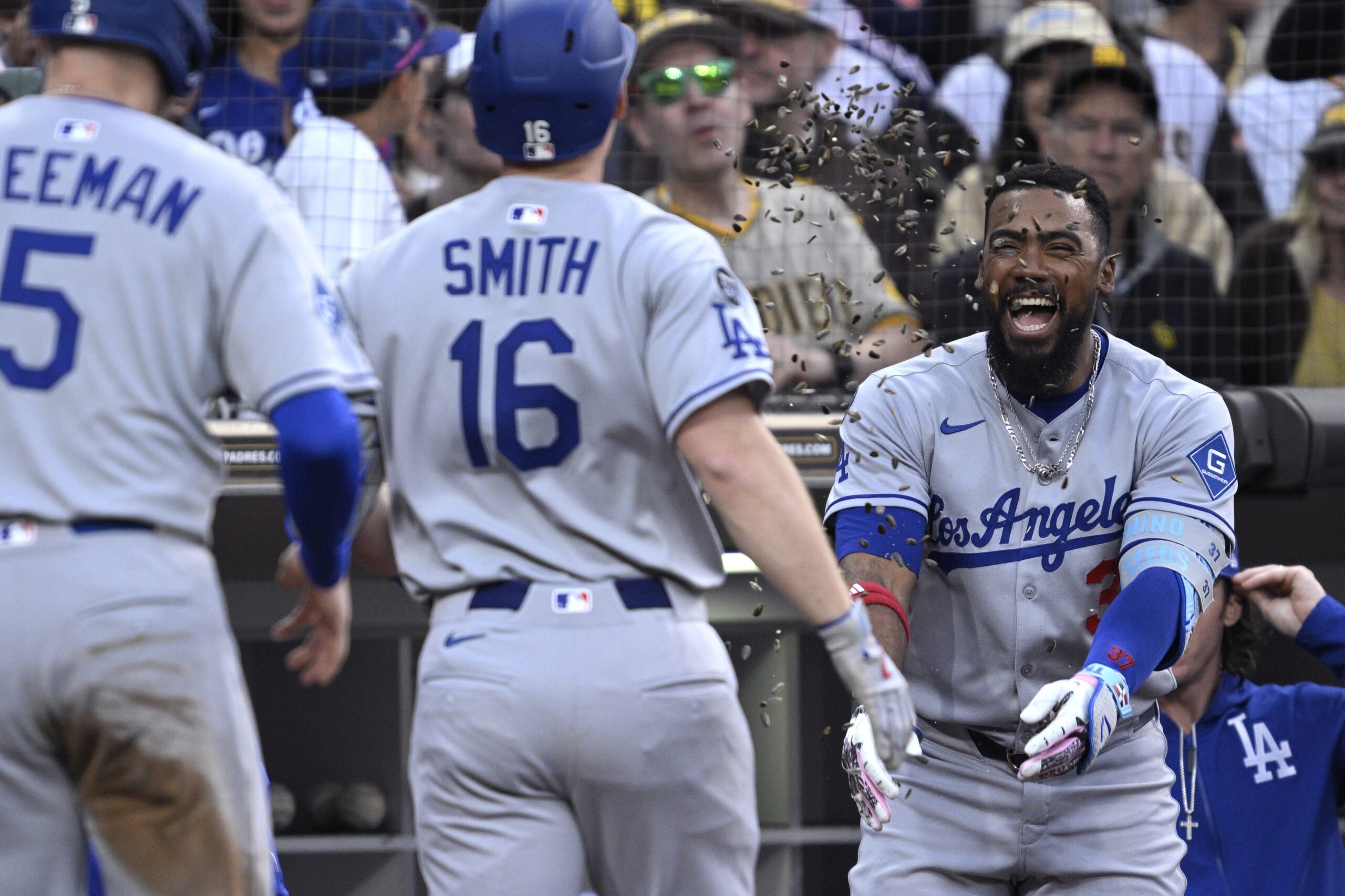 The Dodgers’ Will Smith (16) has sunflower seeds tossed at...