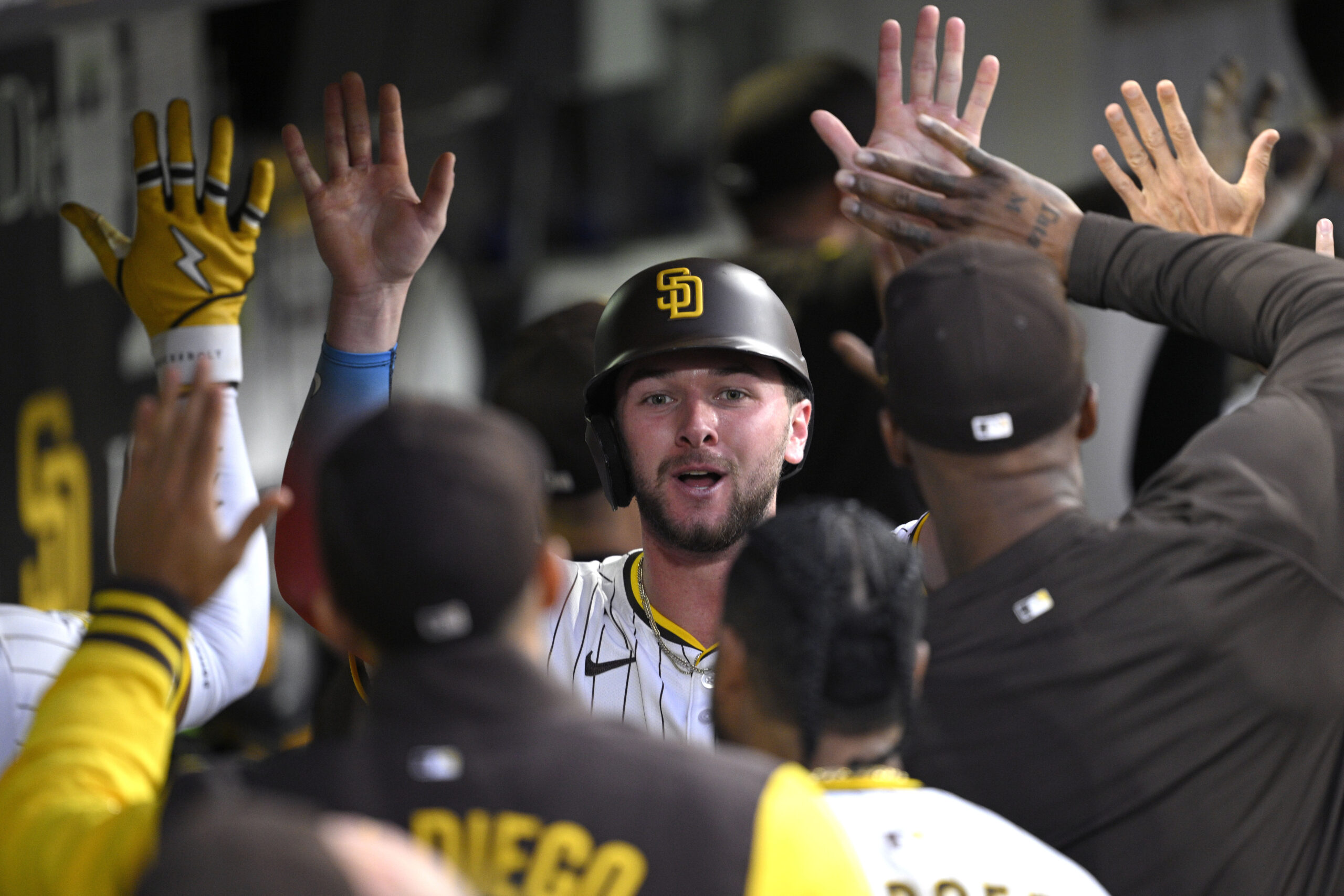The San Diego Padres’ Jackson Merrill is congratulated in the...