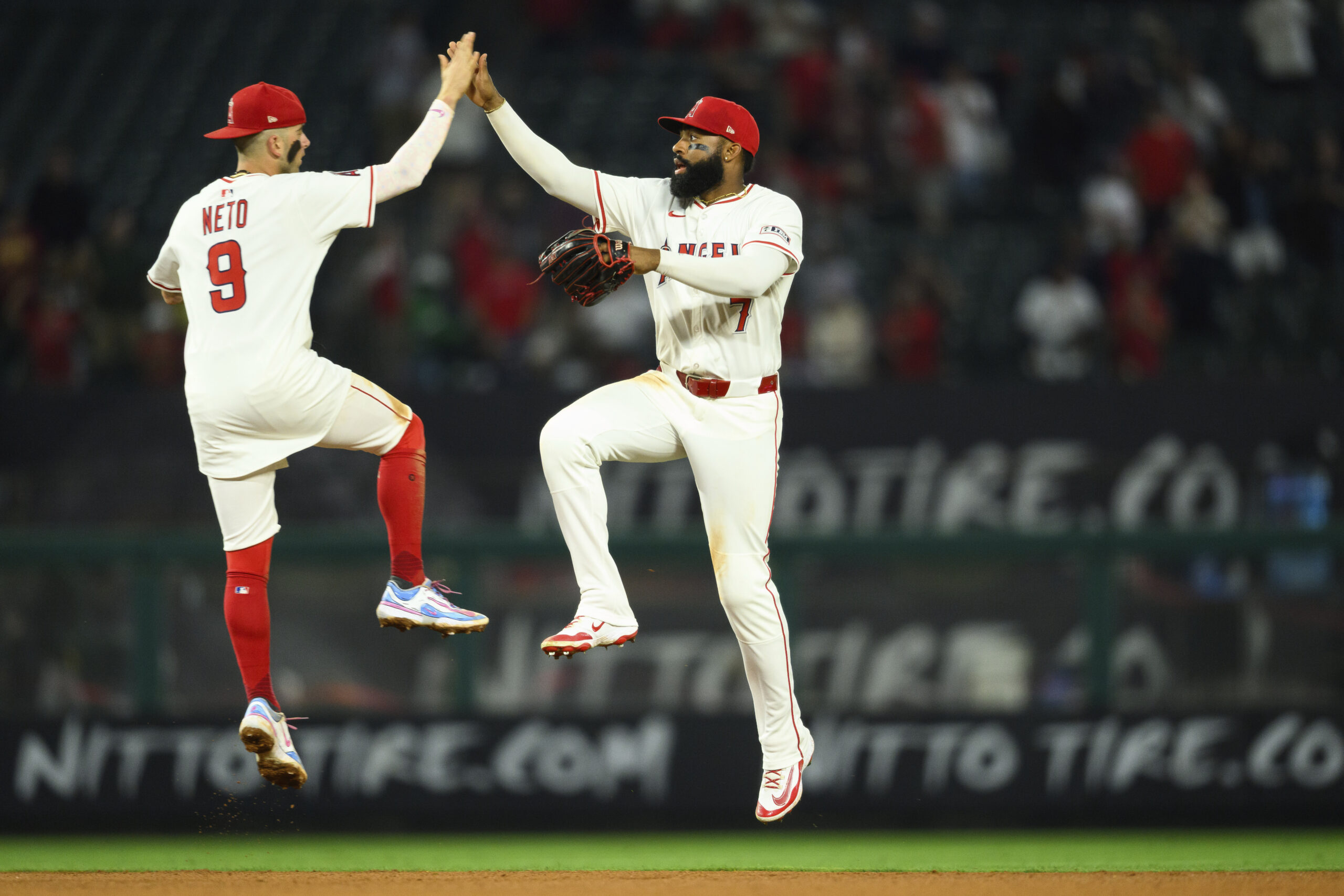 Angels center fielder Jo Adell, right, celebrates with shortstop Zach...