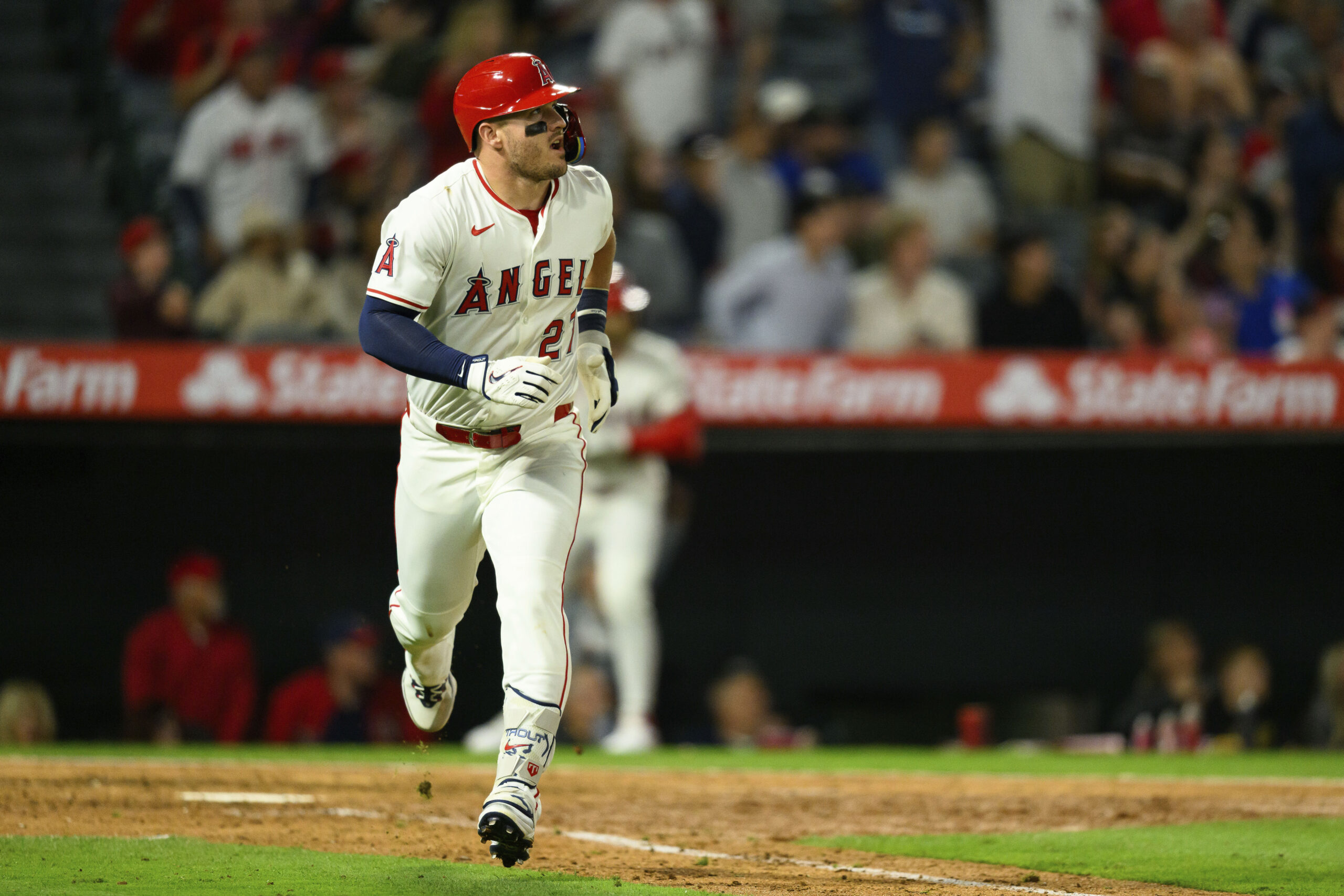 Angels star Mike Trout looks on after hitting a sacrifice...
