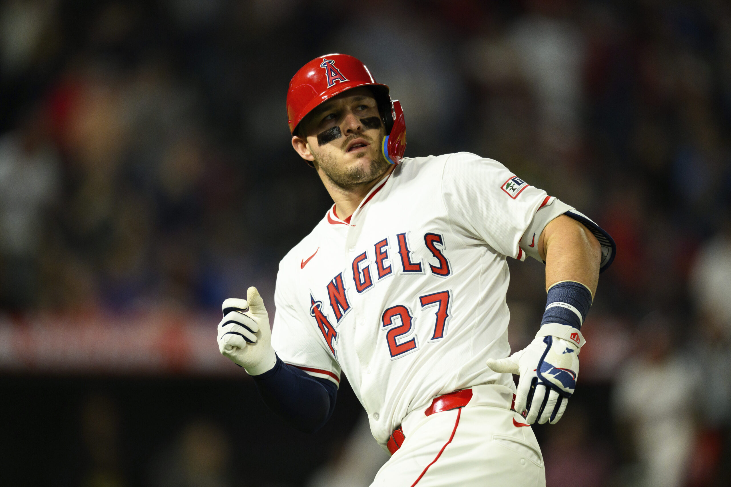 Angels star Mike Trout looks on after hitting a sacrifice...
