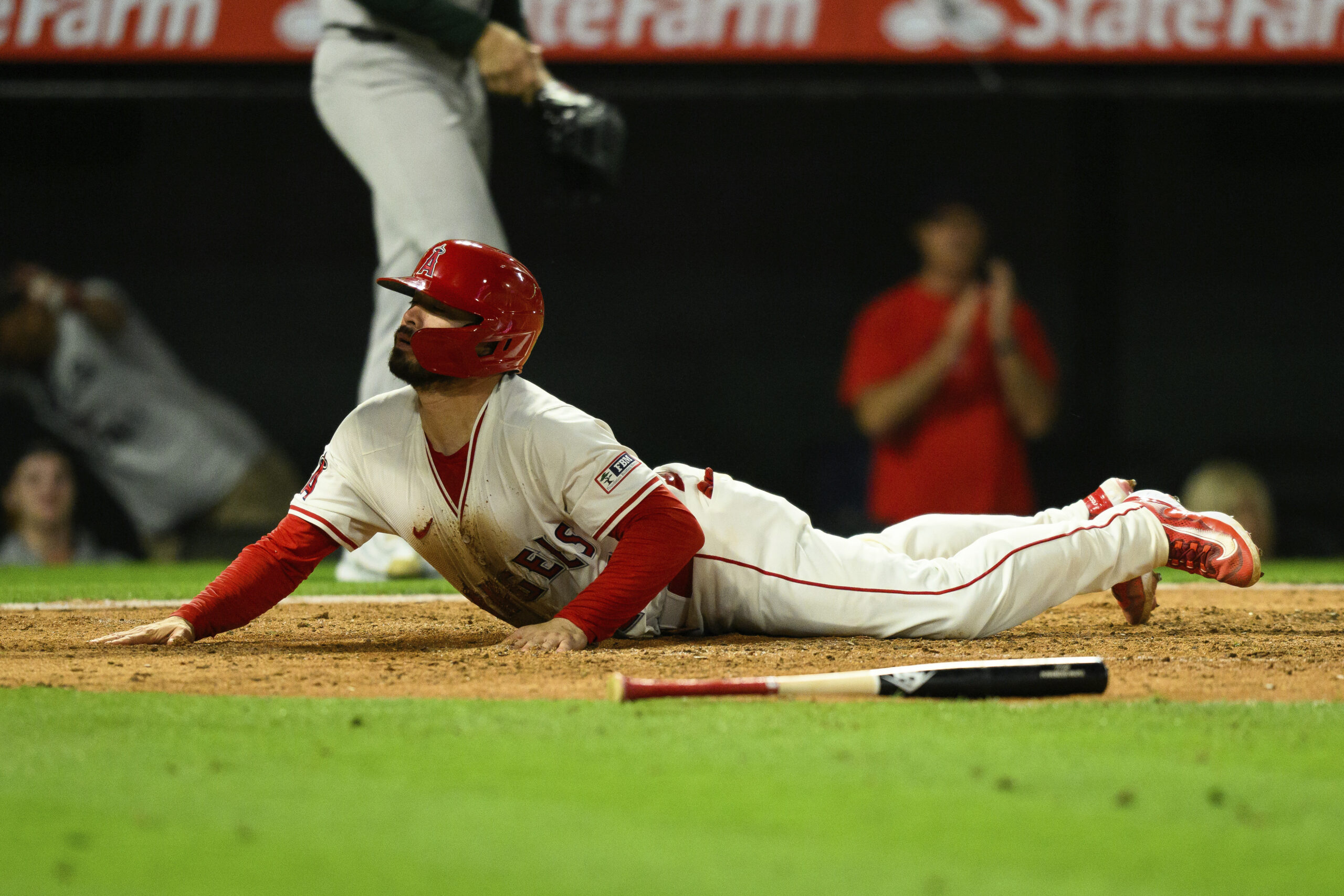 The Angels’ Travis d’Arnaud slides into home plate to score...