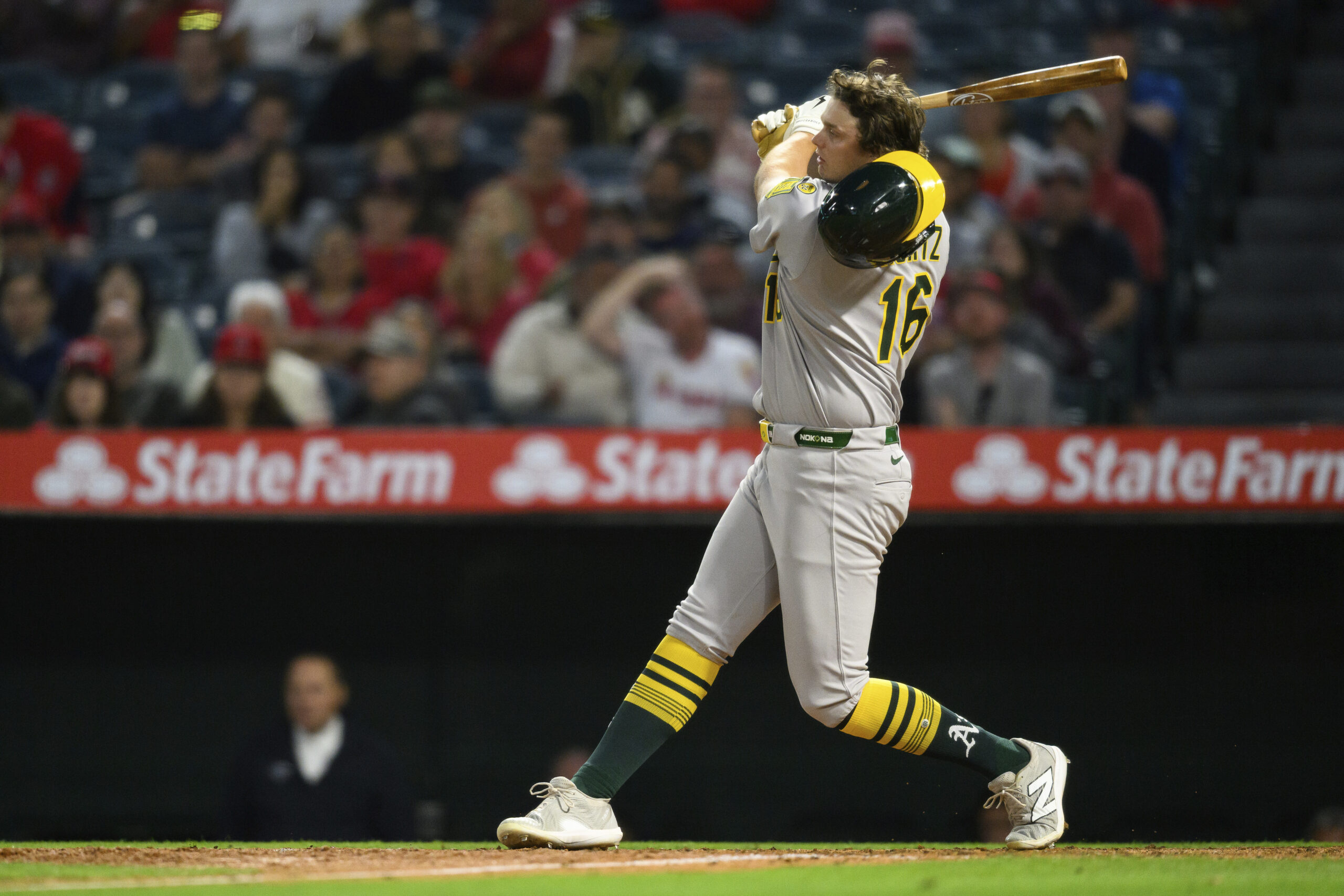 The Athletics’ Nick Kurtz loses his helmet swinging during the...