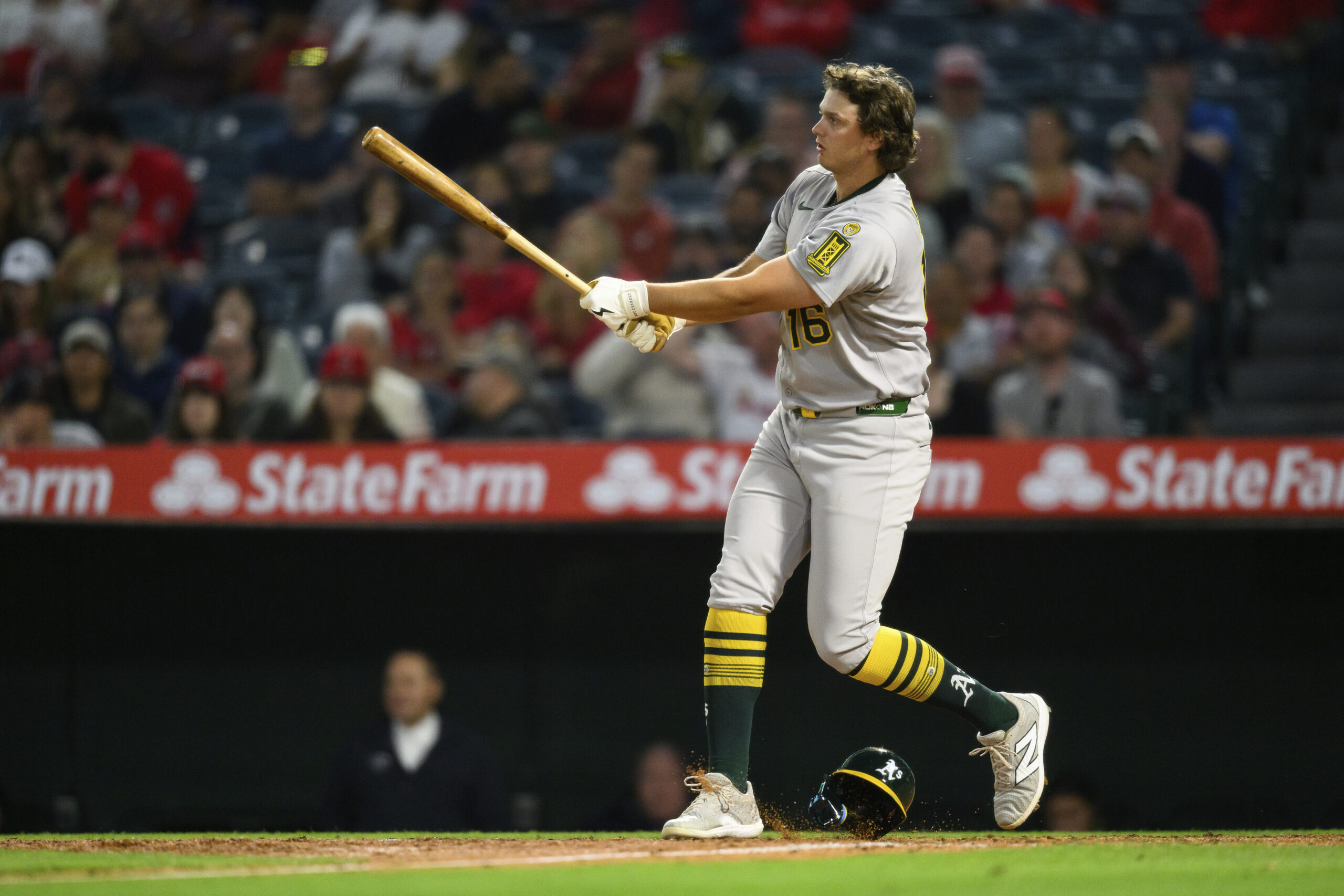 The Athletics’ Nick Kurtz loses his helmet swinging during the...
