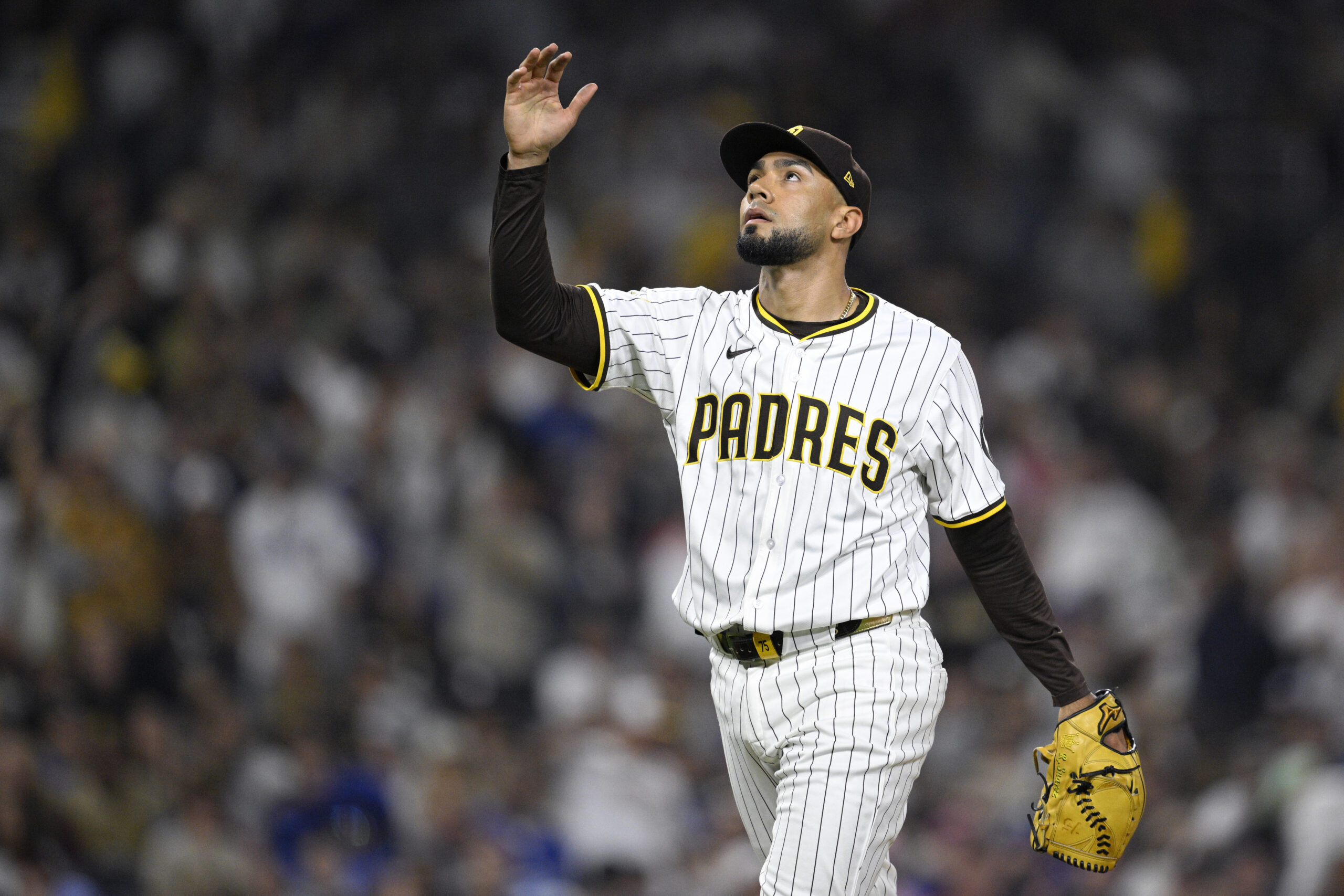 San Diego Padres relief pitcher Robert Suarez celebrates after striking...