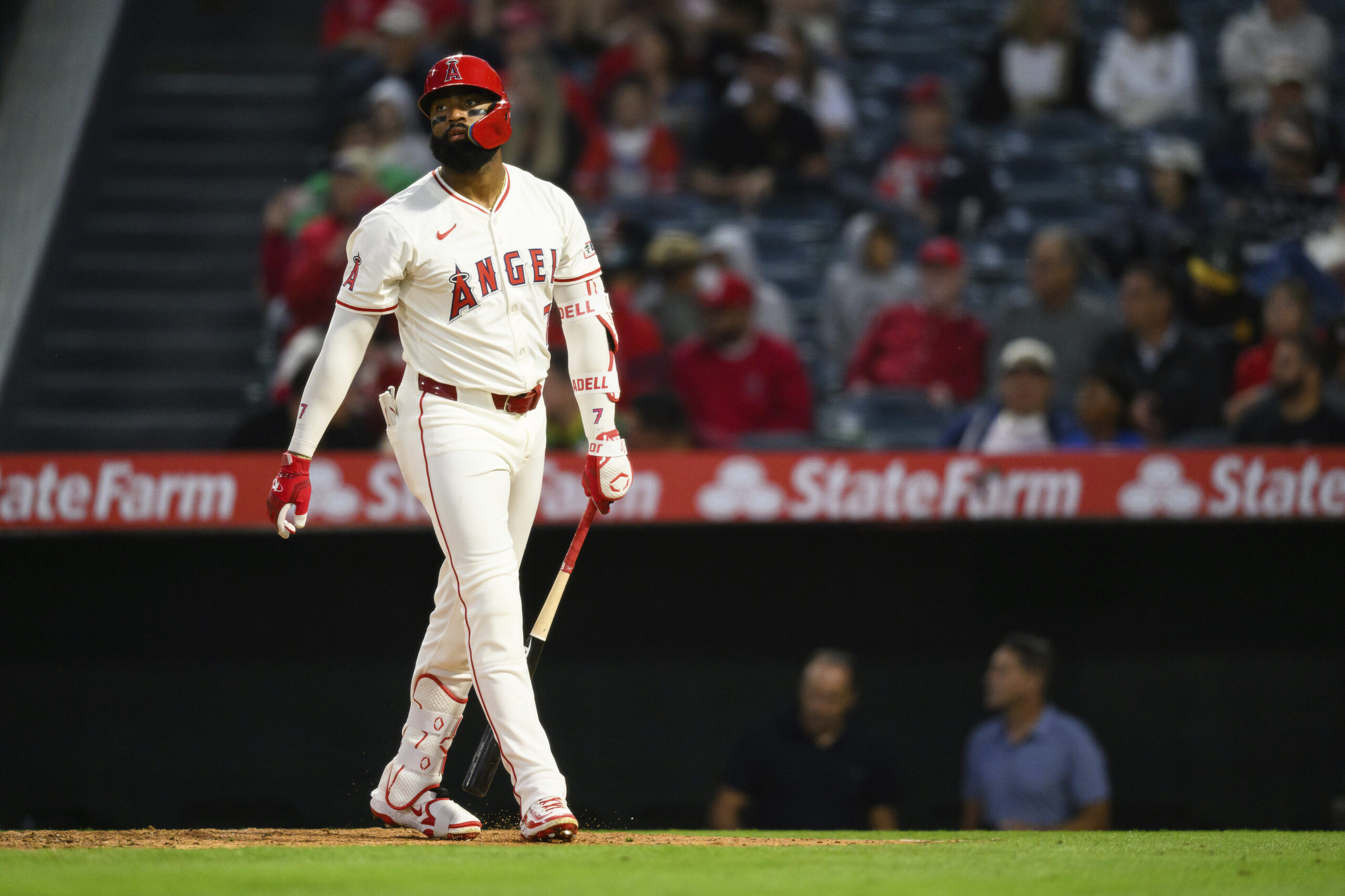 The Angels’ Jo Adell reacts after hitting a fly ball...