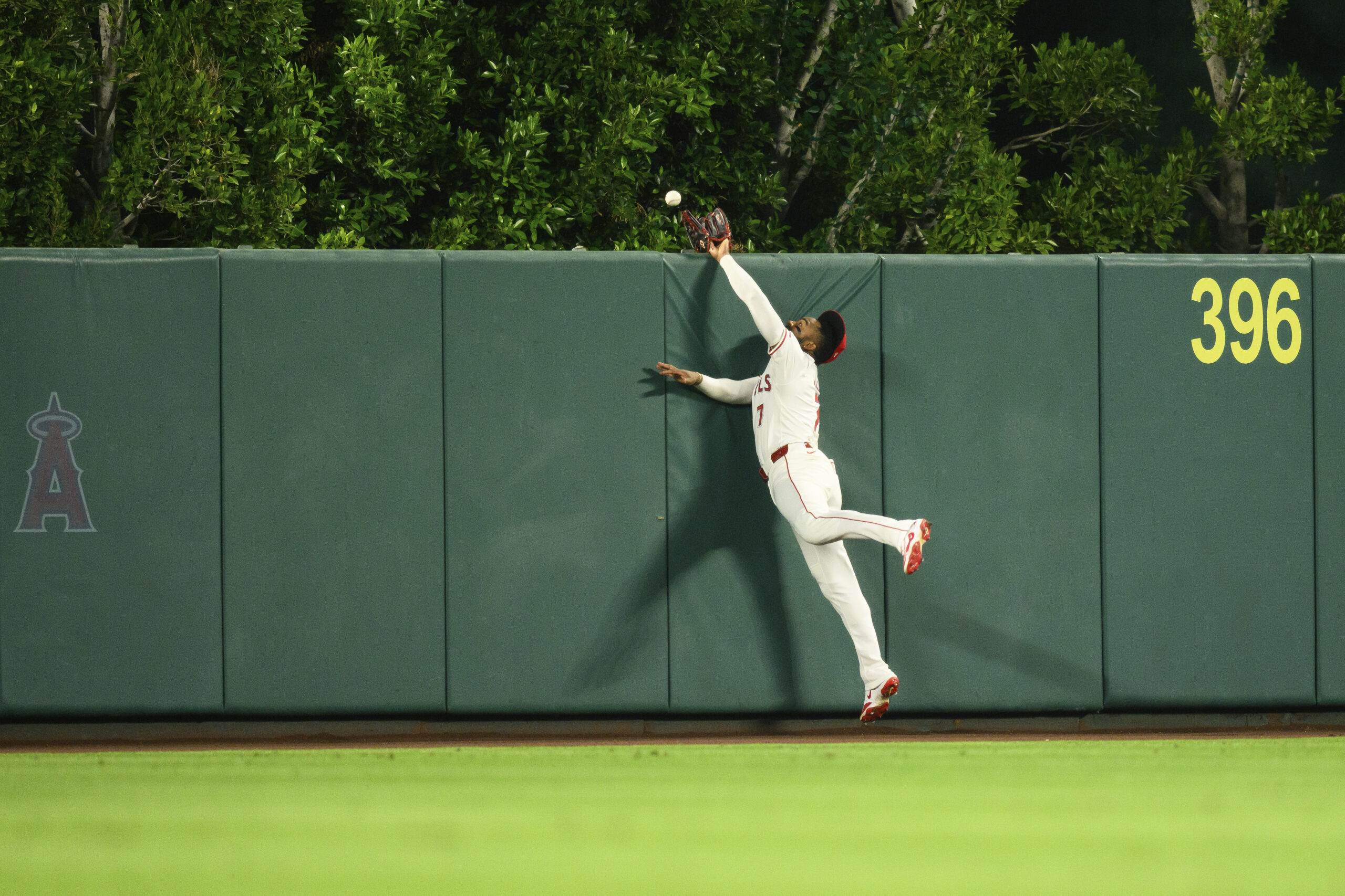 Angels center fielder Jo Adell tries to rob the A’s...