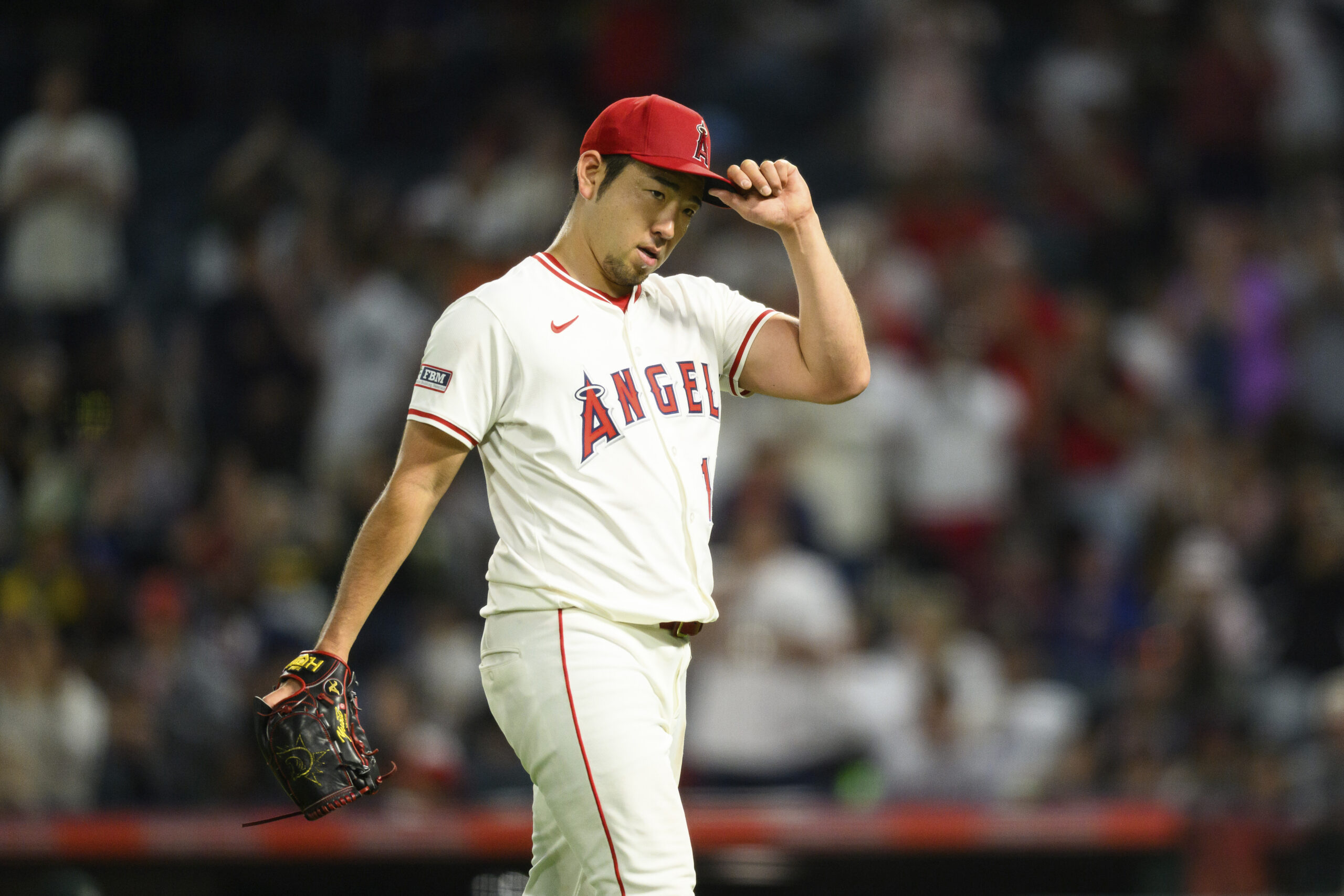 Angels starting pitcher Yusei Kikuchi looks on after being substituted...