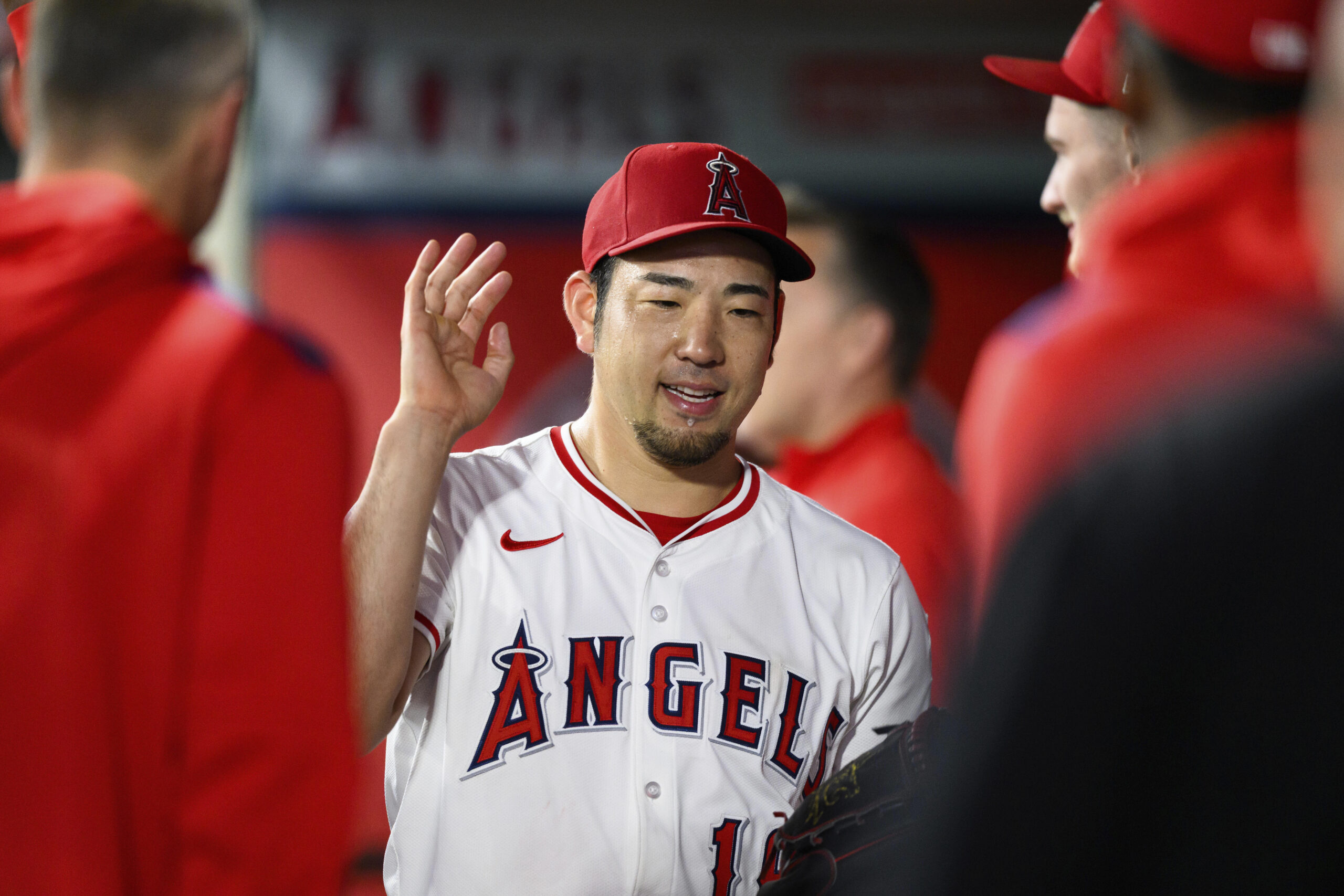 Angels starting pitcher Yusei Kikuchi is greeted by teammates after...