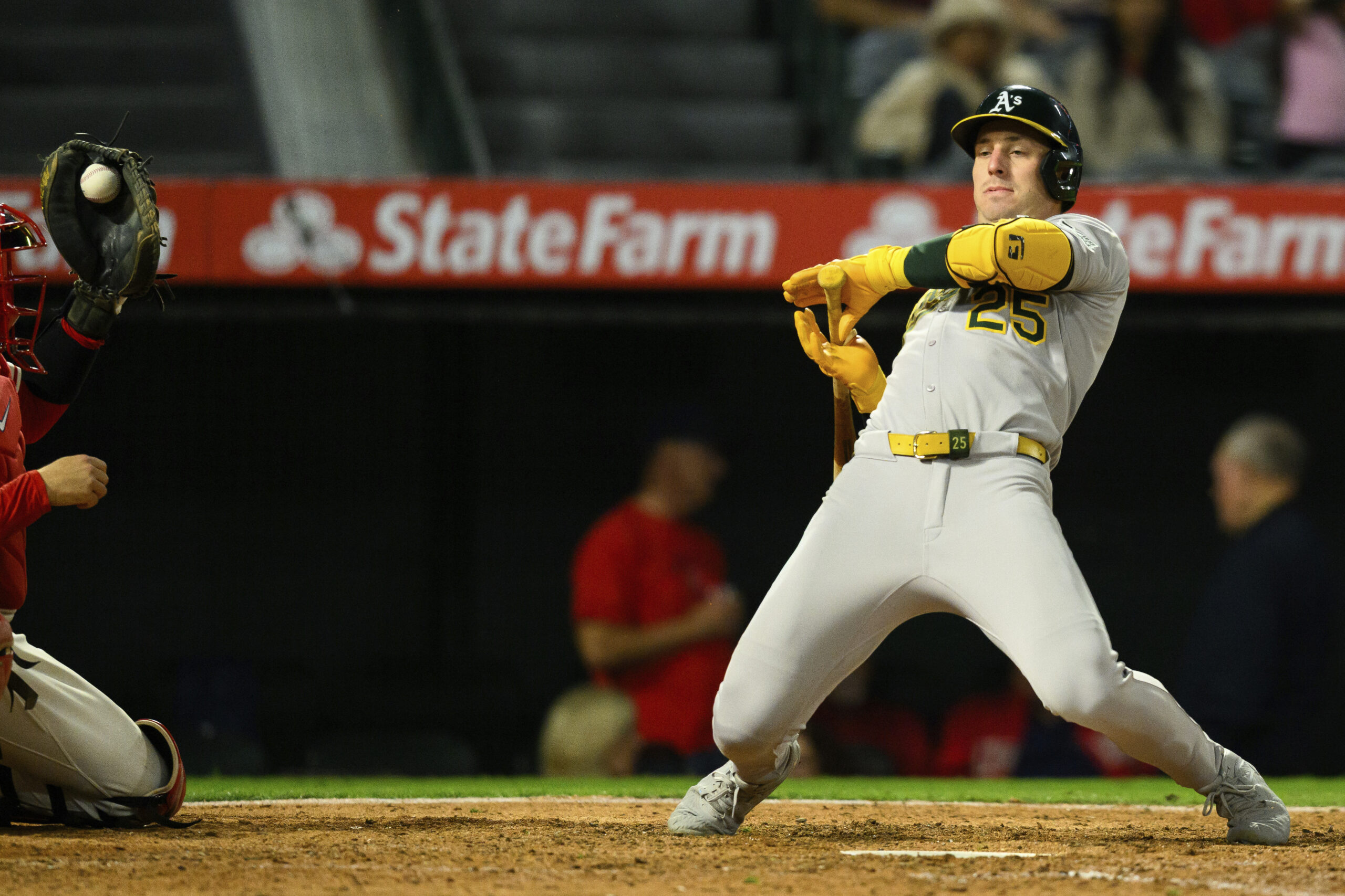 The Athletics’ Brent Rooker reacts after a close pitch during...
