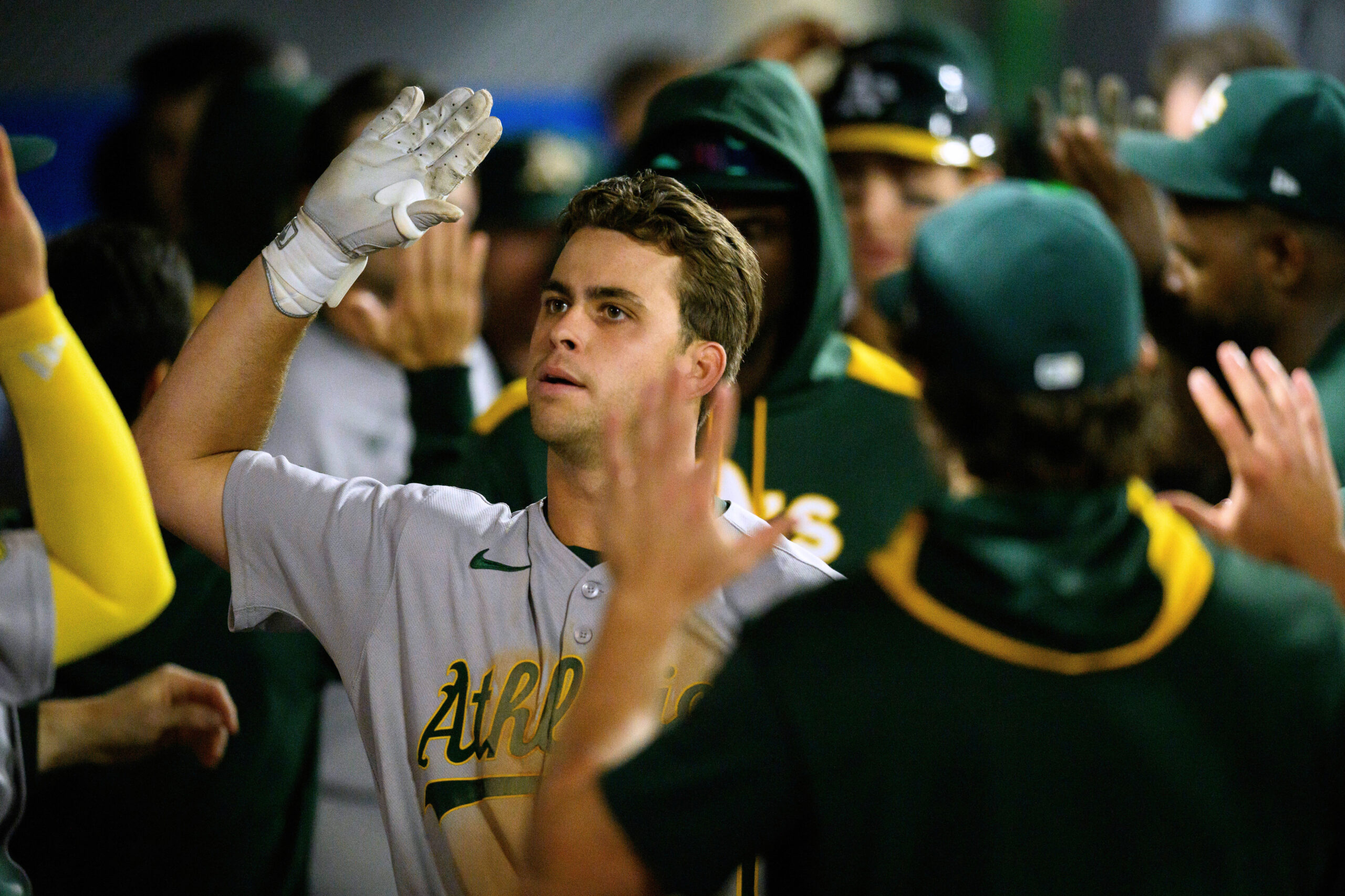 The Athletics’ Max Muncy is greeted by teammates in the...