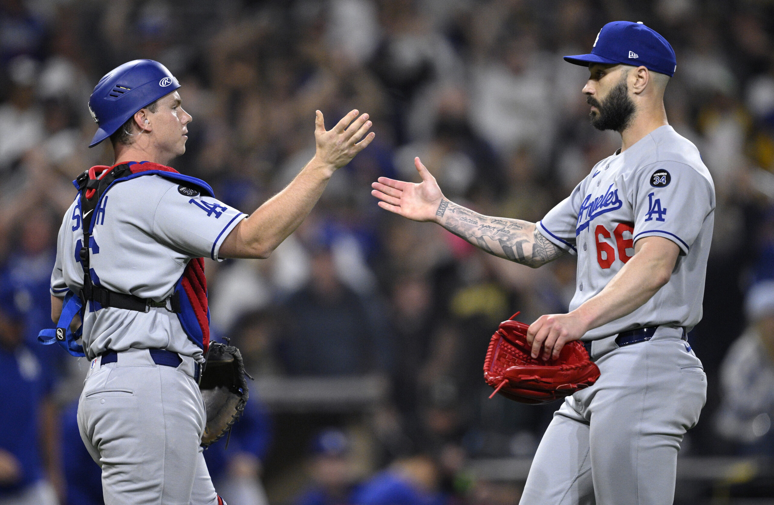 Dodgers catcher Will Smith, left, and relief pitcher Tanner Scott...