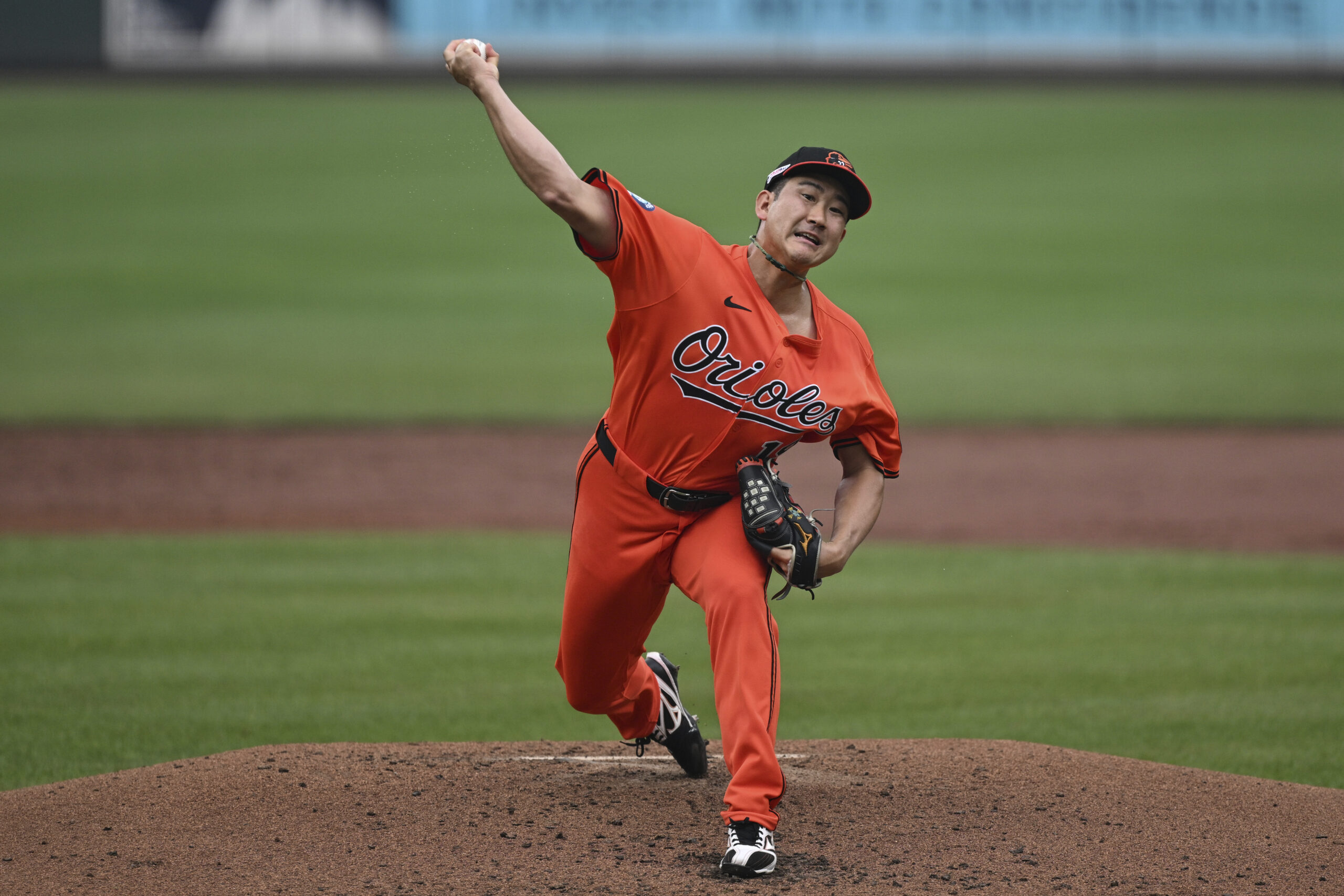 Baltimore Orioles pitcher Tomoyuki Sugano throws during the third inning...